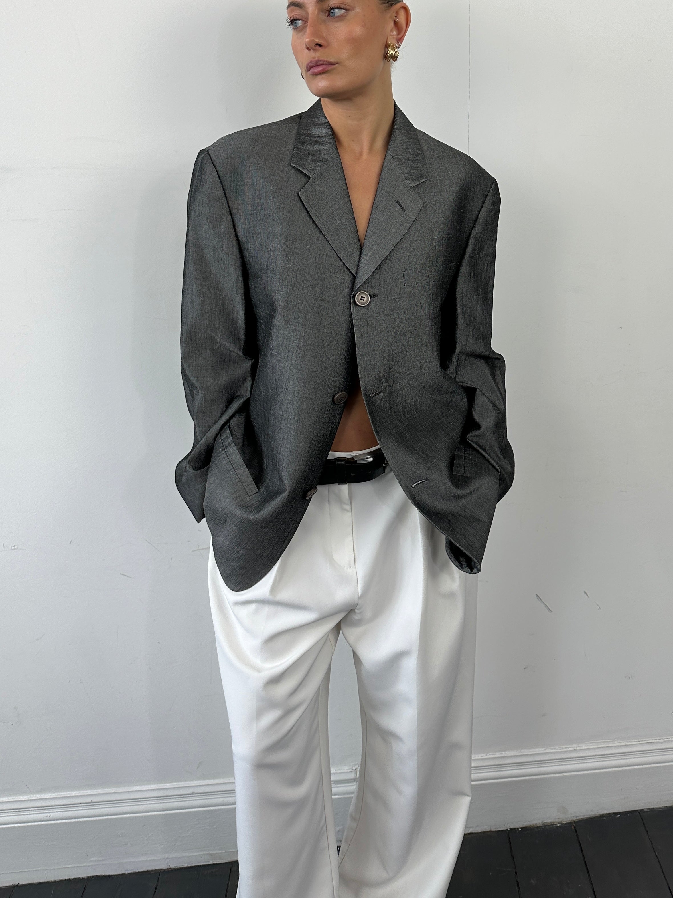 Versace Versus single-breasted blazer in size L, tailored fit, with classic lapels and stylish design, shown on a hanger.