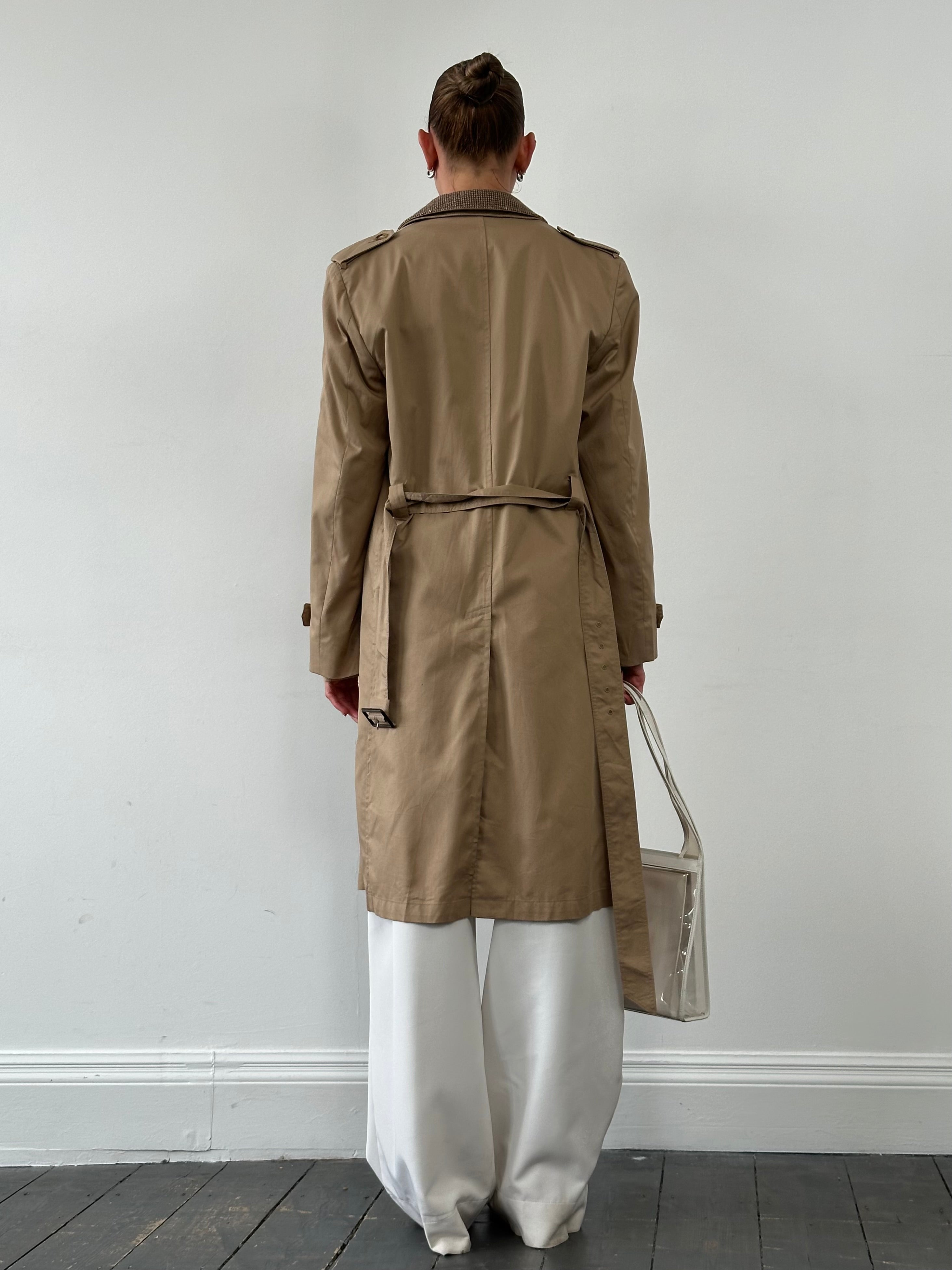 Christian Dior Monsieur cotton single-breasted belted trench coat displayed on a hanger, showcasing classic design and neutral color.