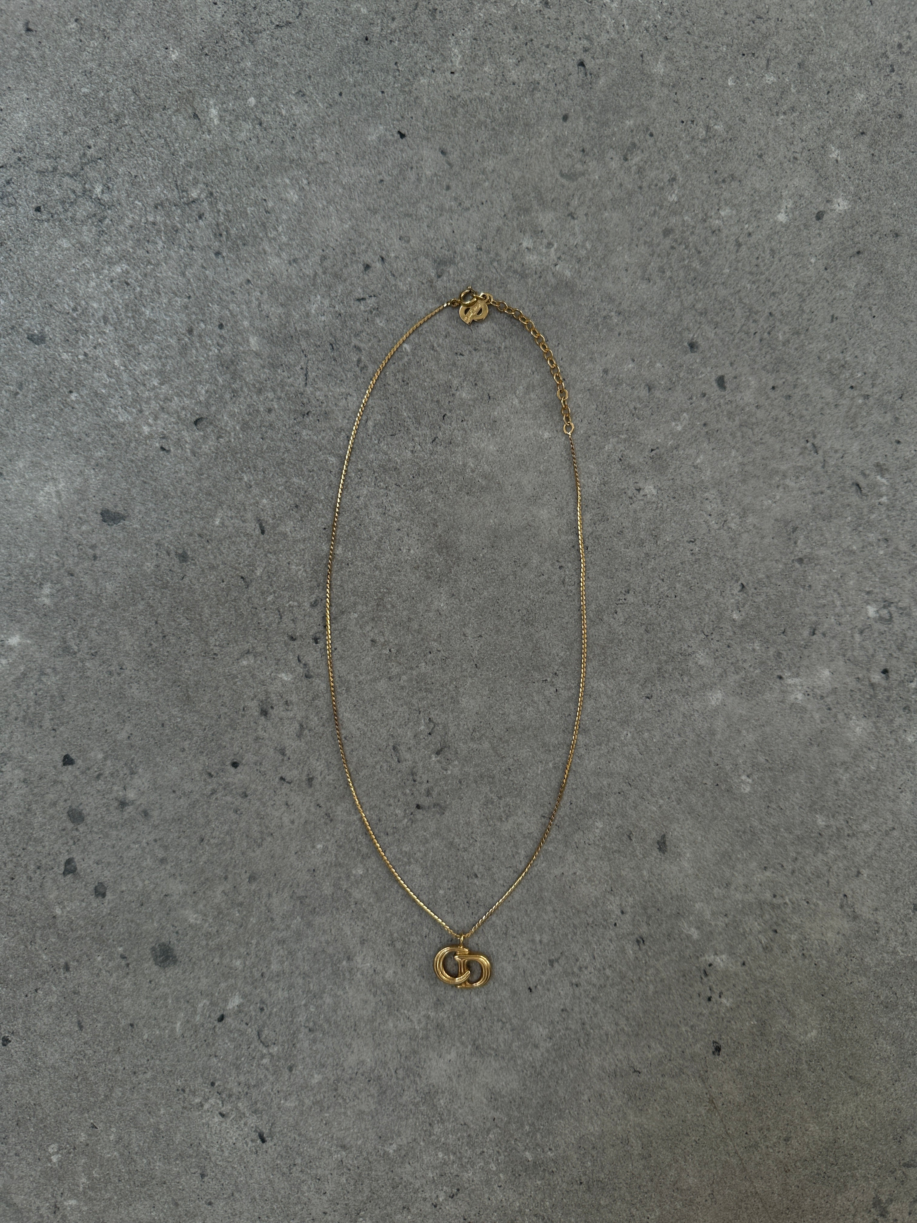 Christian Dior 16-inch gold plated logo pendant necklace with a sleek, polished finish and iconic Dior branding.