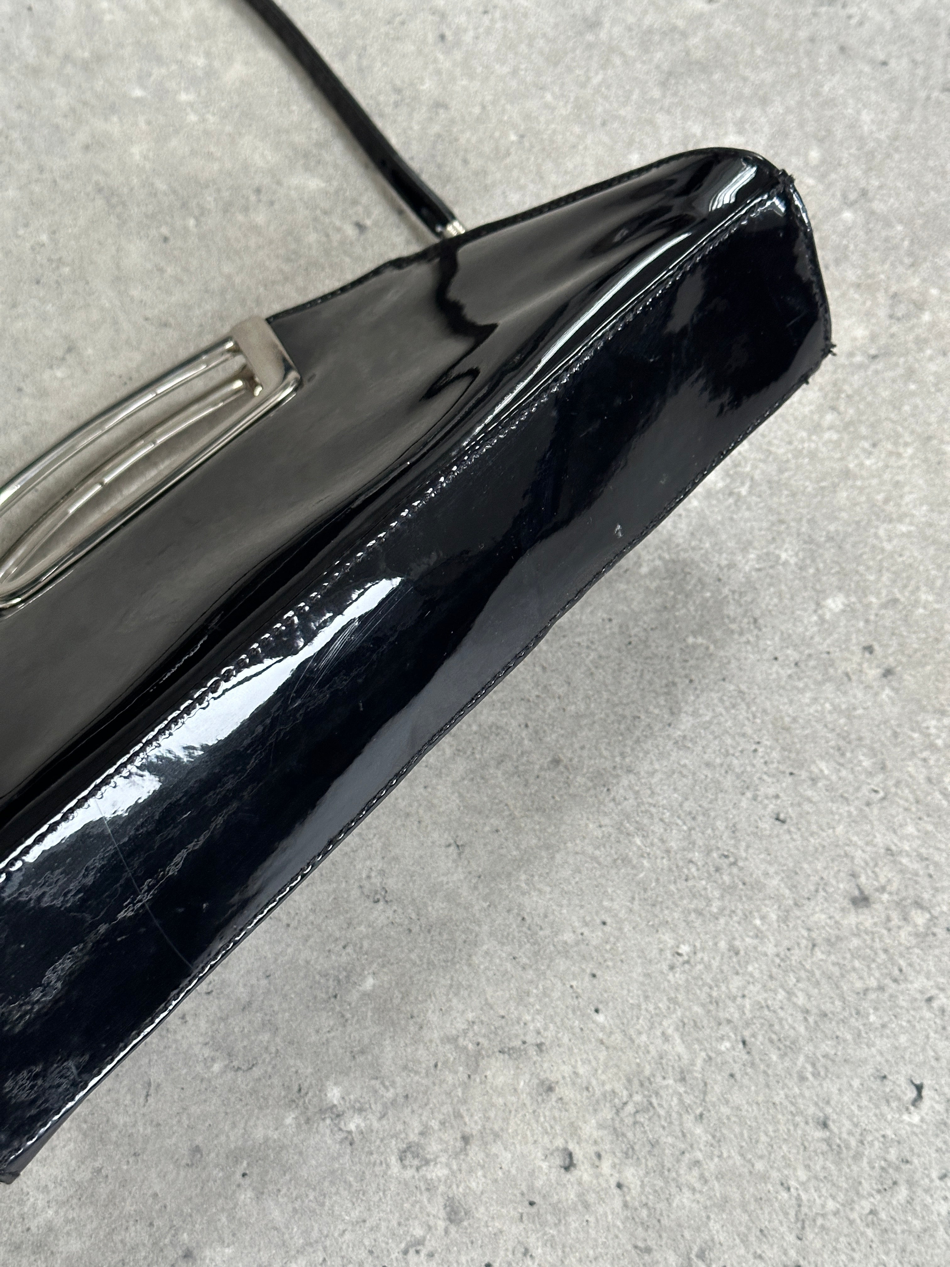 Vintage 2000s patent vinyl chrome crossbody clutch bag with a sleek design and metallic finish.