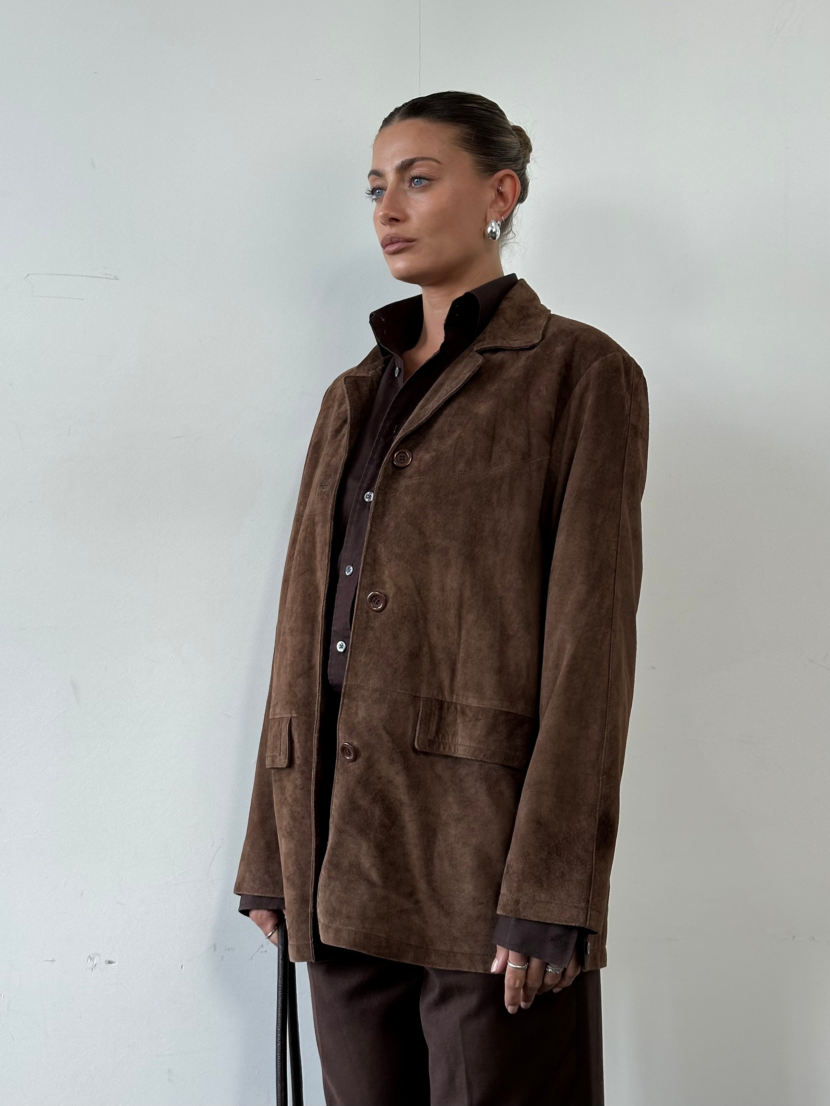 Vintage suede jacket in size large, stylish and classic design, shown in a close-up of the soft, textured suede material.