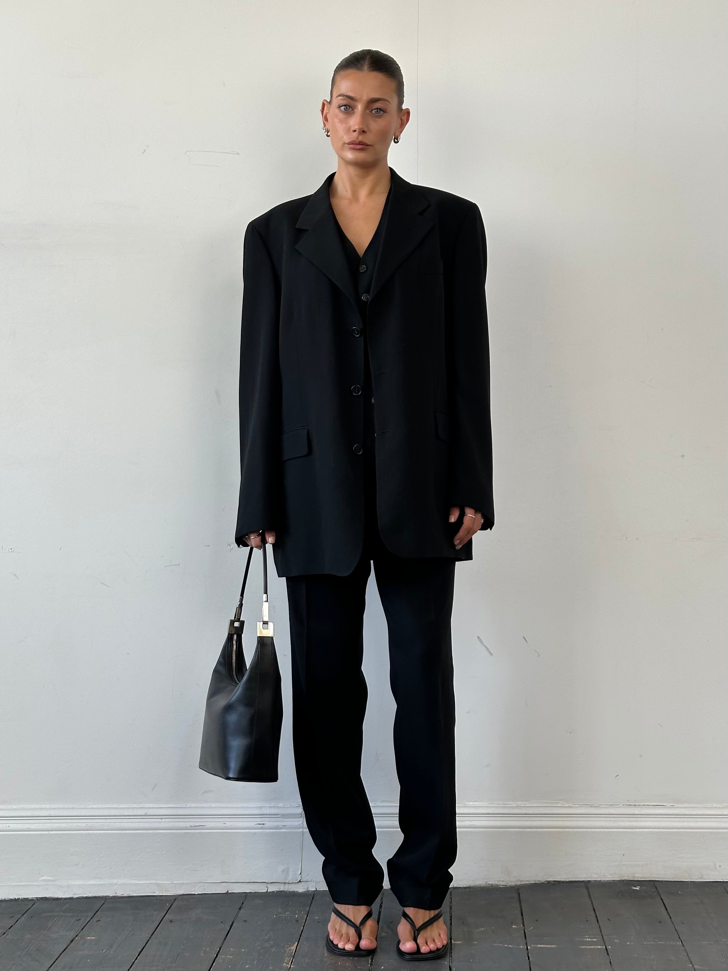 Yves Saint Laurent Pour Homme pure wool three-piece suit, size 46L/W34, displayed on a hanger showing jacket, waistcoat, and trousers.