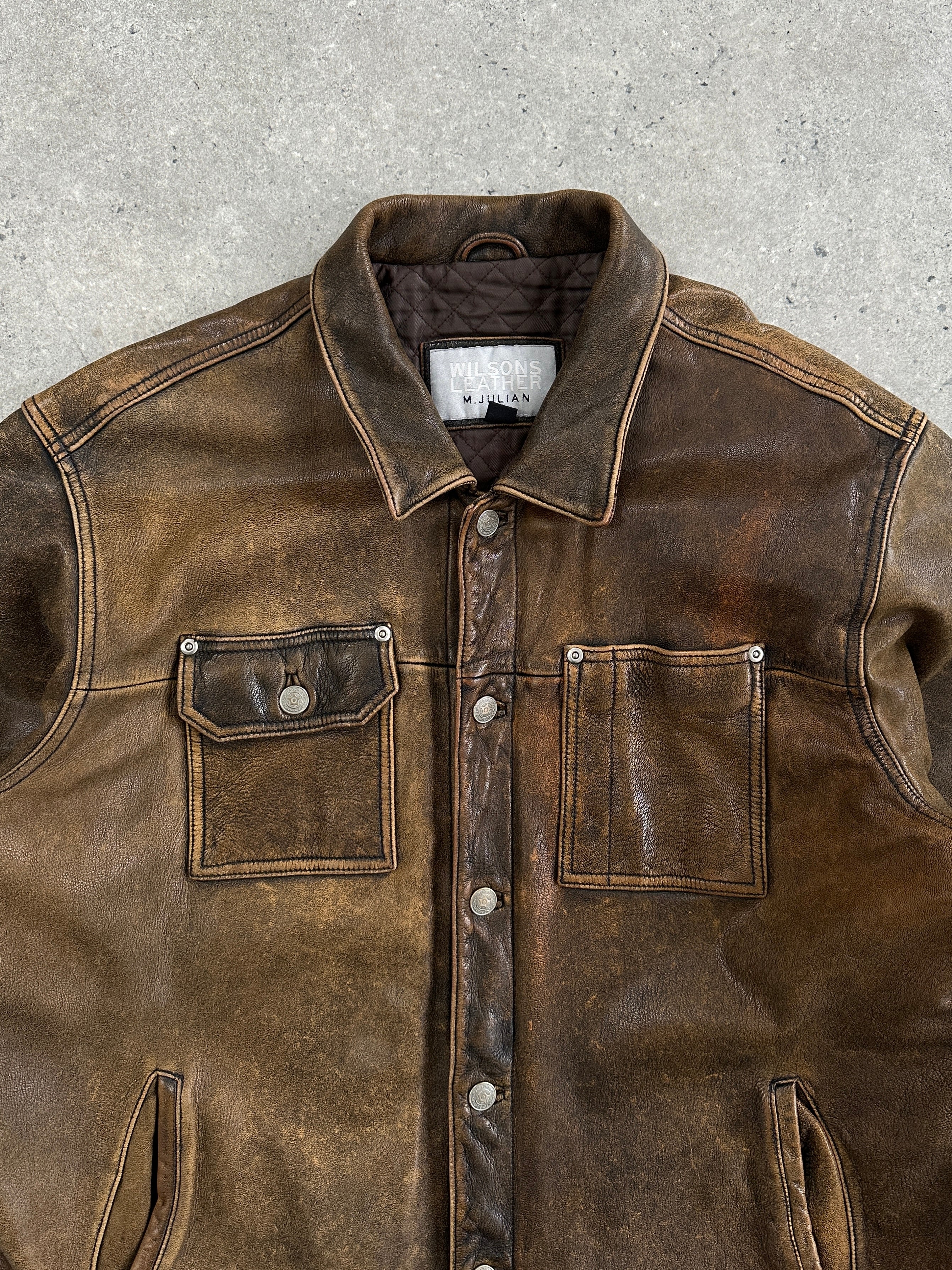 Vintage aged leather trucker jacket in XL with classic design, featuring weathered leather and sturdy stitching.