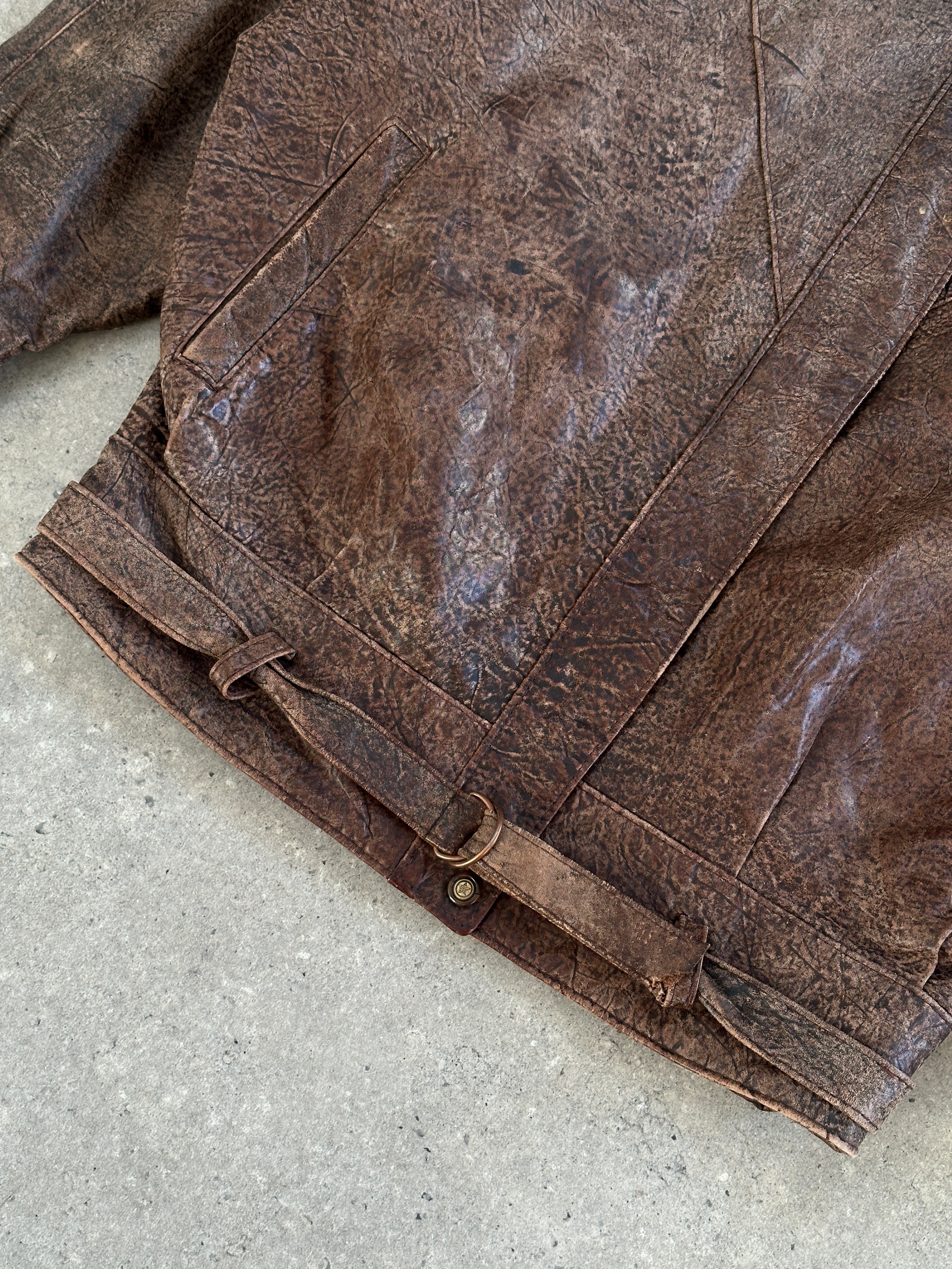 Vintage leather jacket from the 1980s, aged brown leather, size small, with classic collar and distressed finish.