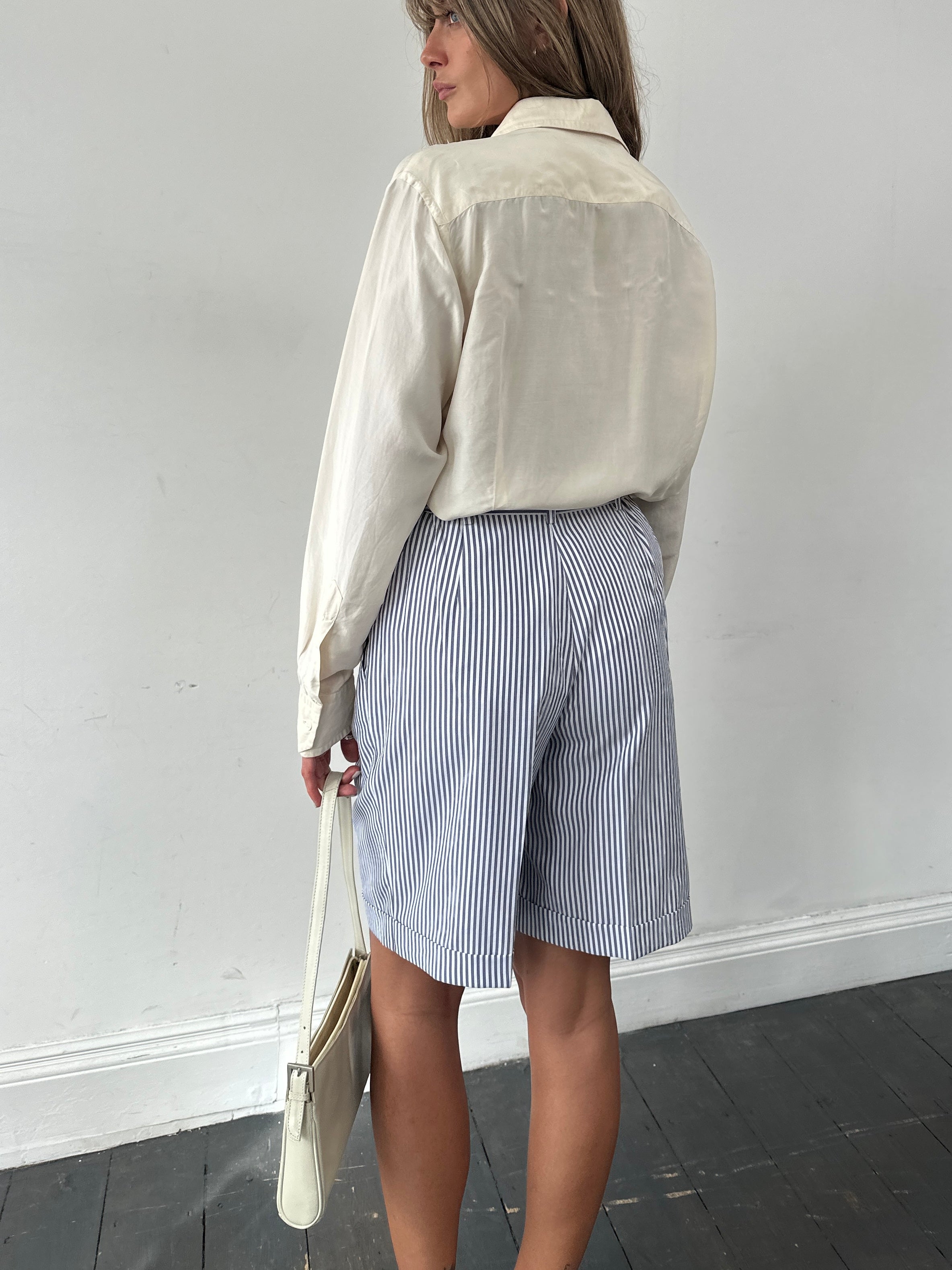 Vintage stripe pleated shorts in W28 with a high waist, featuring a colorful vertical stripe pattern and tailored pleats.