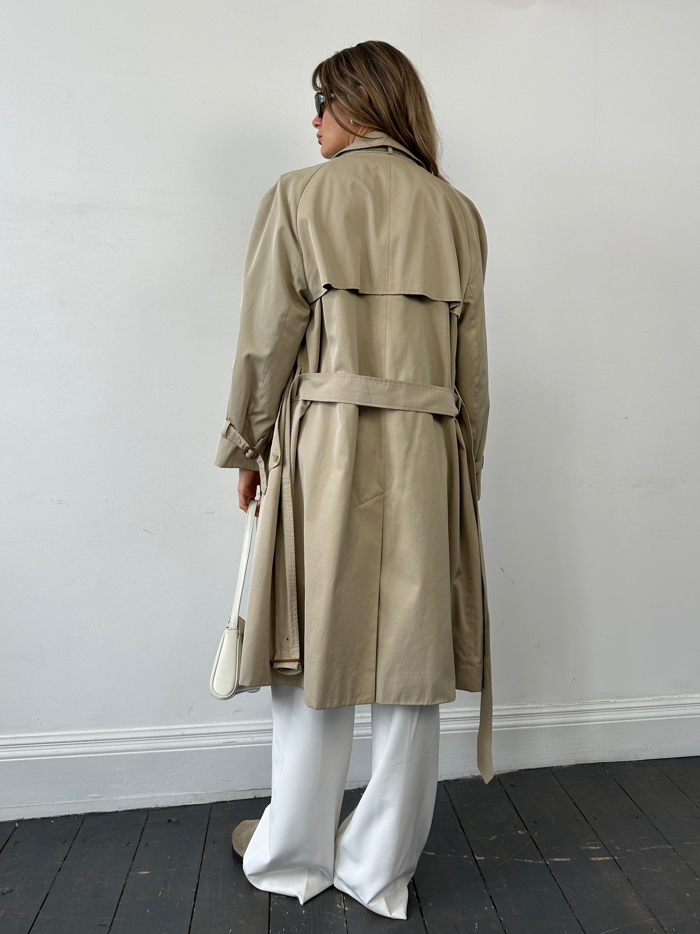 Aquascutum pure cotton trench coat with concealed placket and belt, shown in a size L, featuring classic design and neutral color.