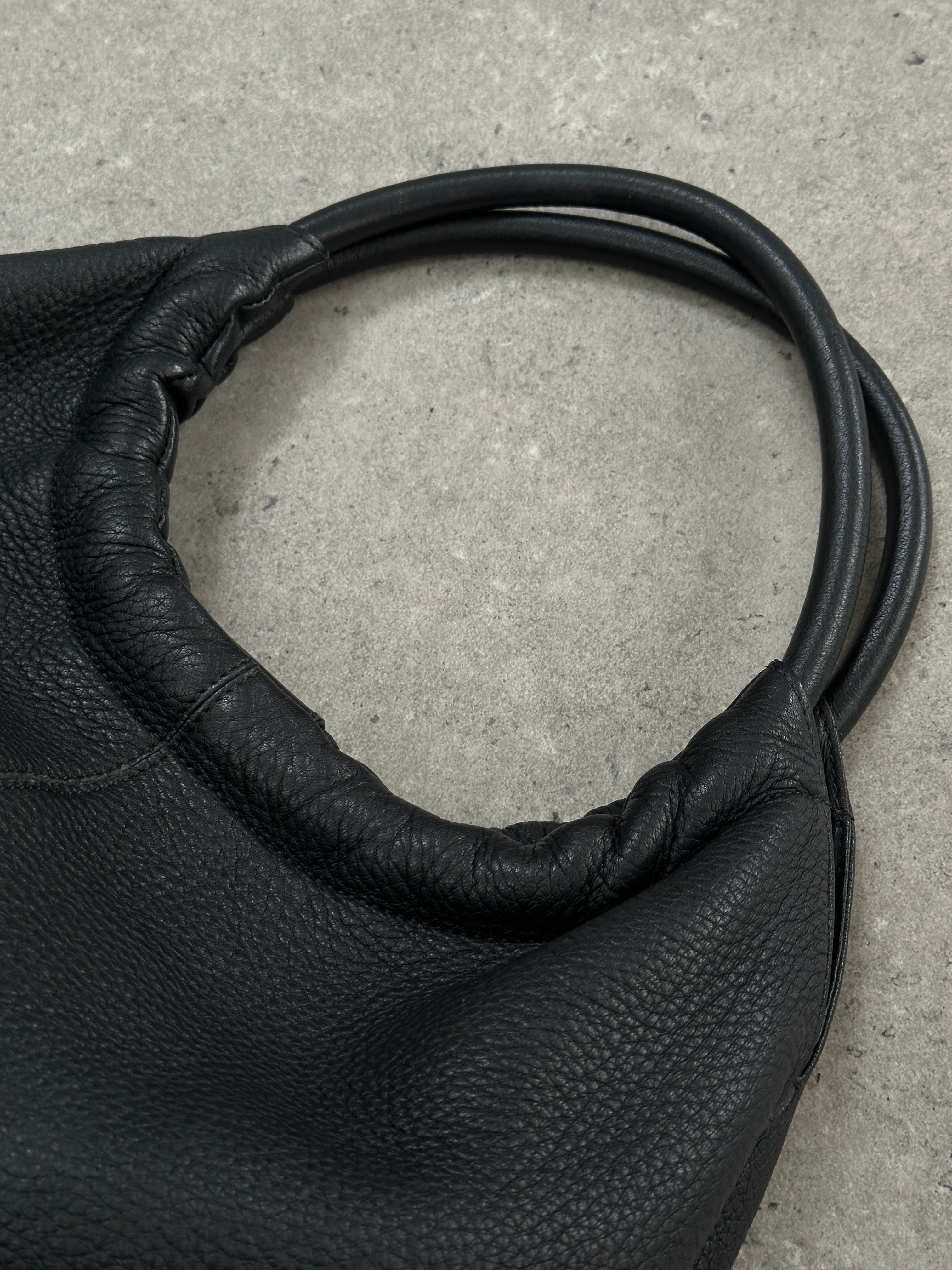 Giorgio Armani 2000s leather hobo shoulder bag with slouchy design and shoulder strap in brown leather.