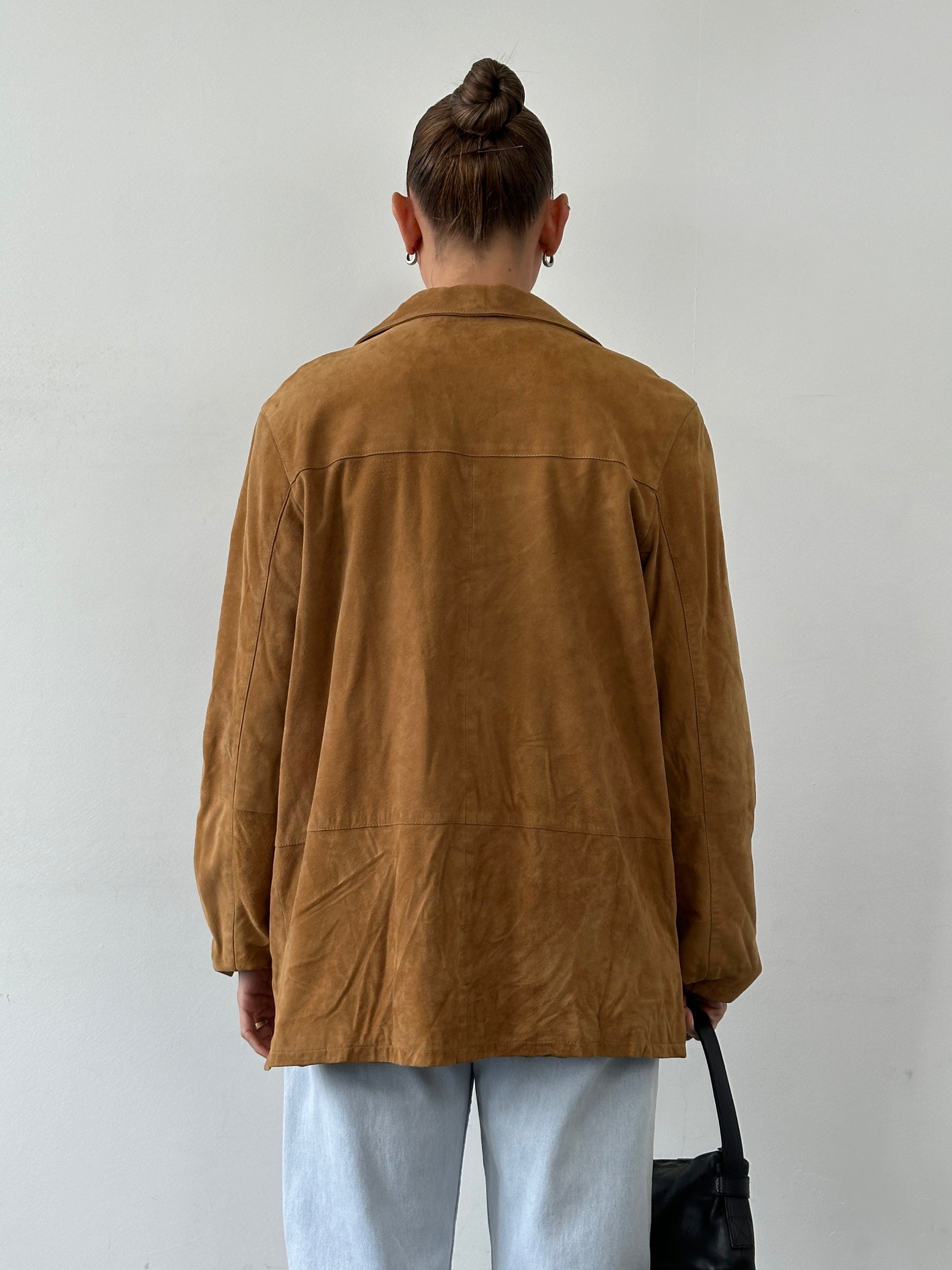 Vintage suede leather jacket in size M/L, featuring classic design and soft texture, displayed on a hanger.
