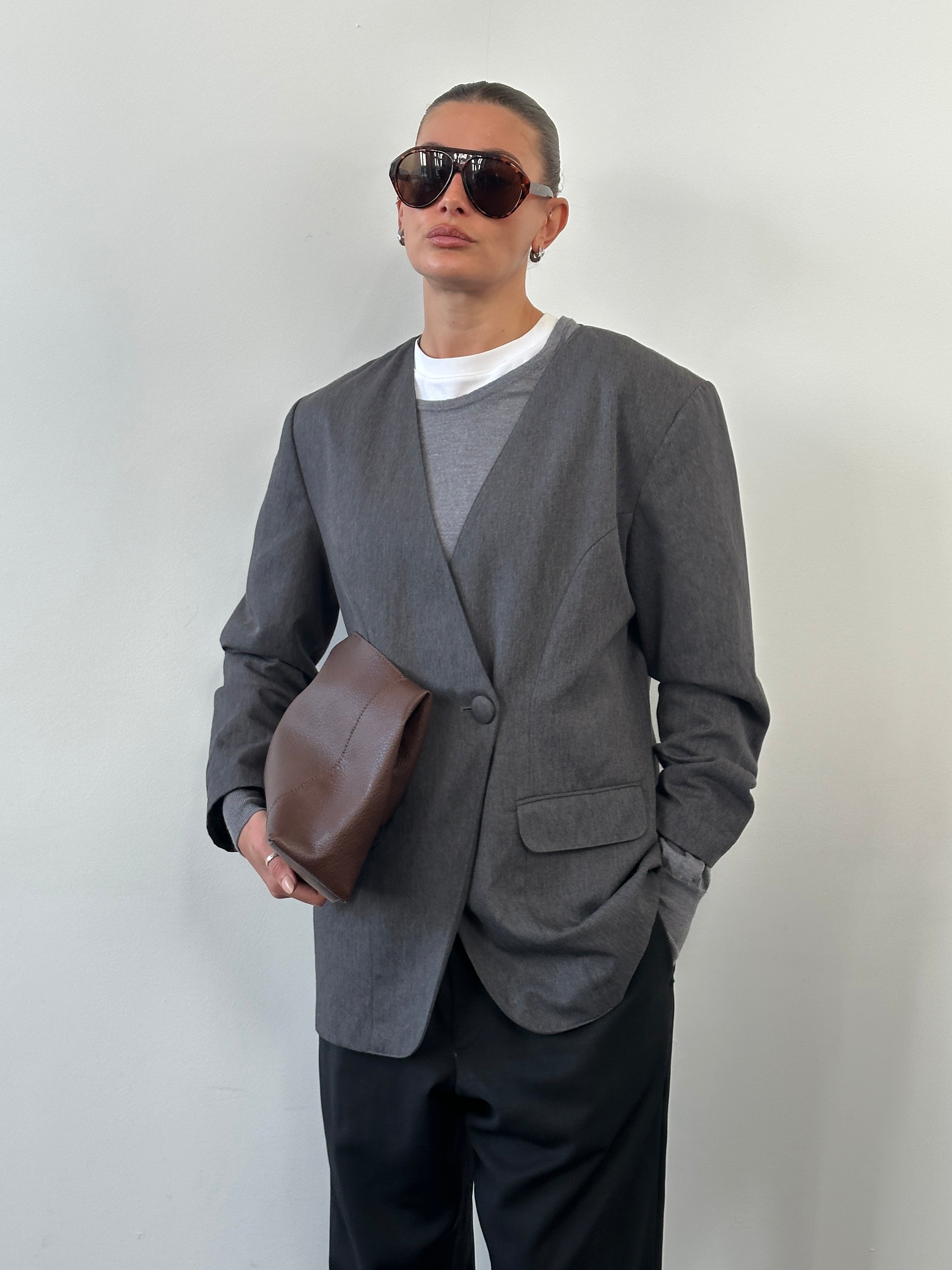 Vintage 1990s minimal collarless blazer in M/L size, classic style with clean lines and tailored fit, shown on a hanger.