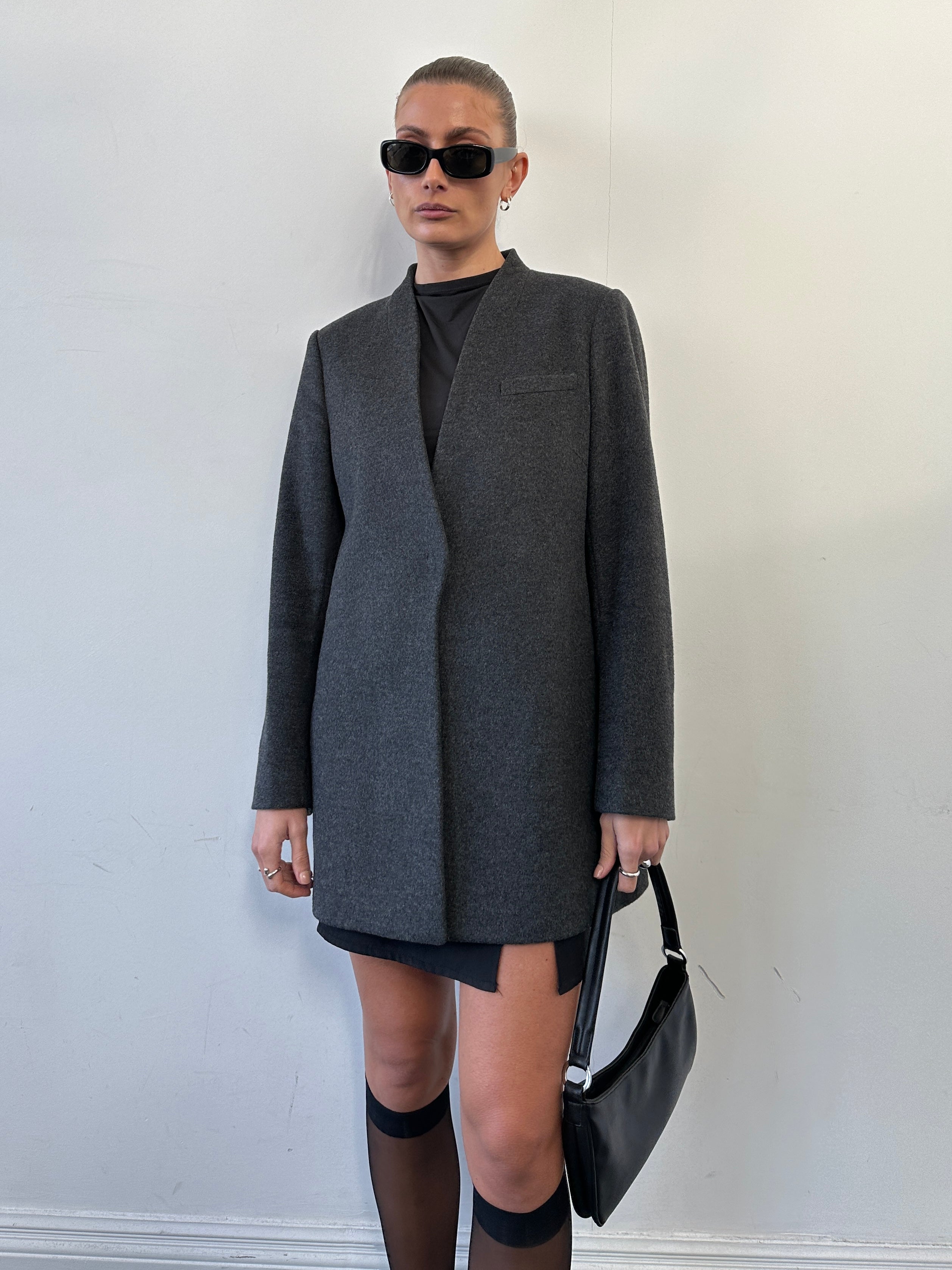 Jaeger minimal wool cashmere coat in size M, stylish outerwear with clean lines and soft fabric, displayed on a hanger.