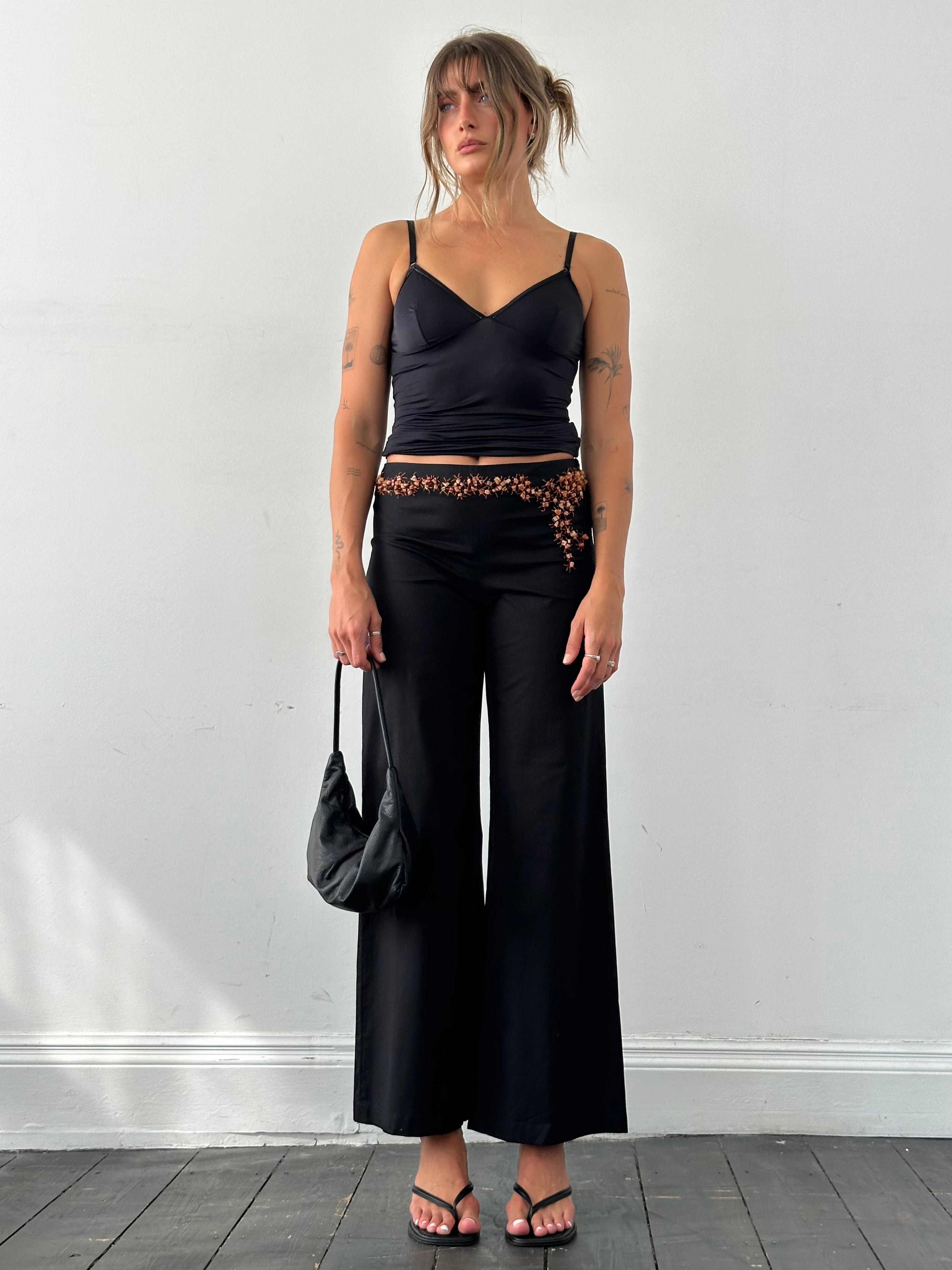Vintage Alberta Ferretti mid waist wide leg trousers with stone embellishments, shown in a natural stance on a neutral background.