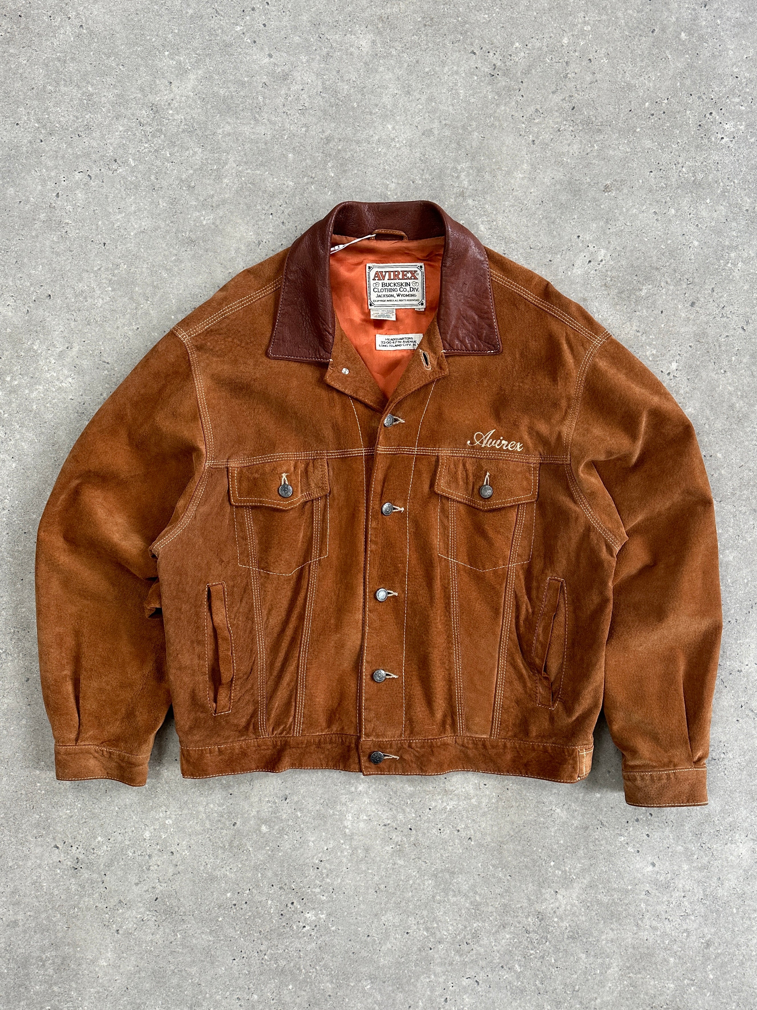 Avirex suede trucker jacket in size L featuring a classic design with a collar, button closure, and textured suede fabric.
