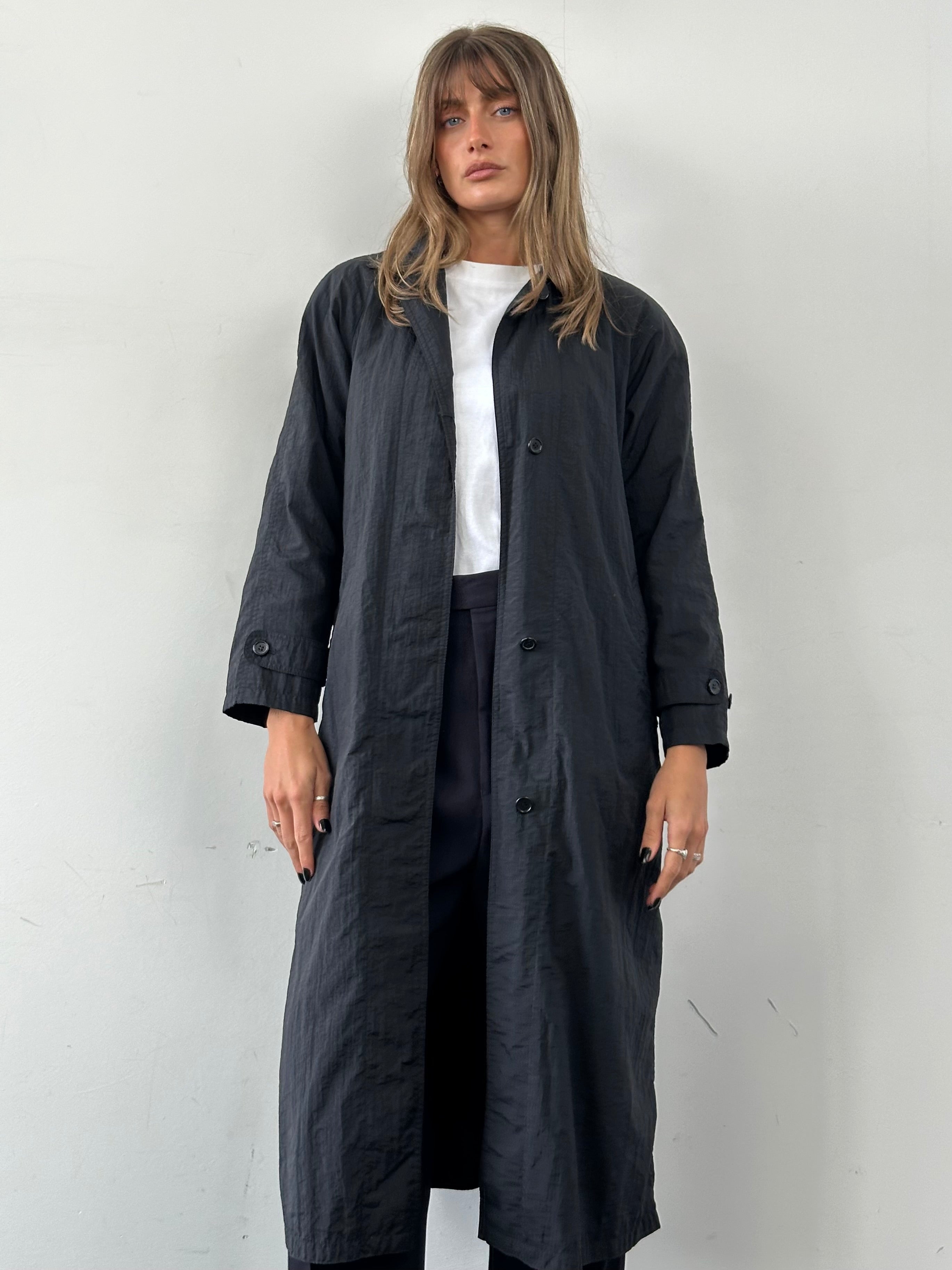 Vintage nylon trench coat with concealed placket, lightweight design, in size small, featuring classic style and durable fabric.