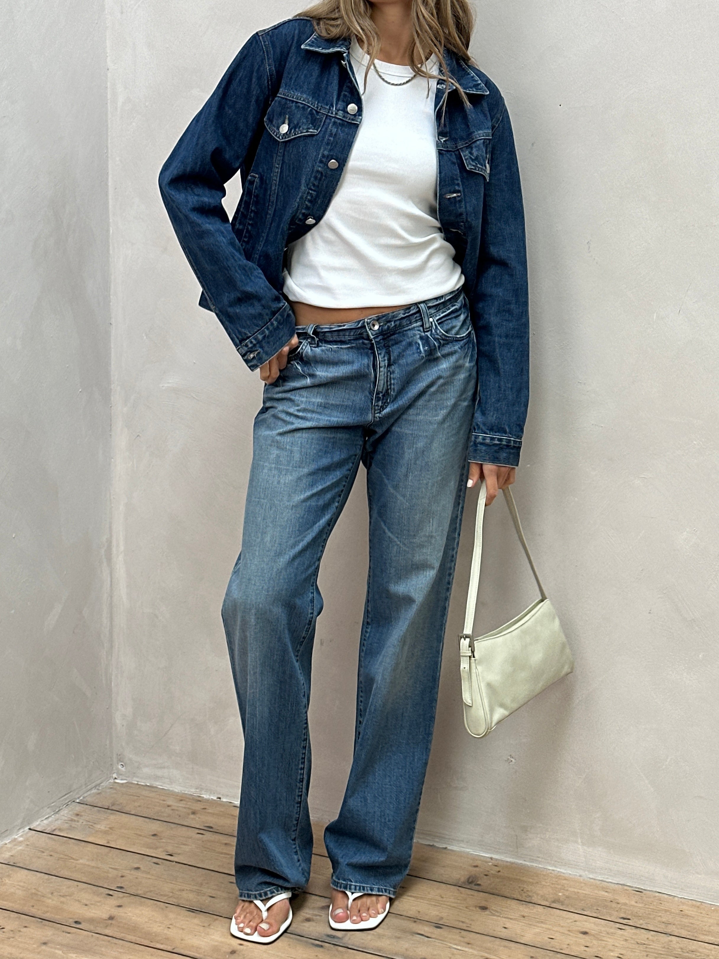 Armani Jeans stonewashed mid-waist denim jeans in size W34, showing the classic fit and faded denim texture.