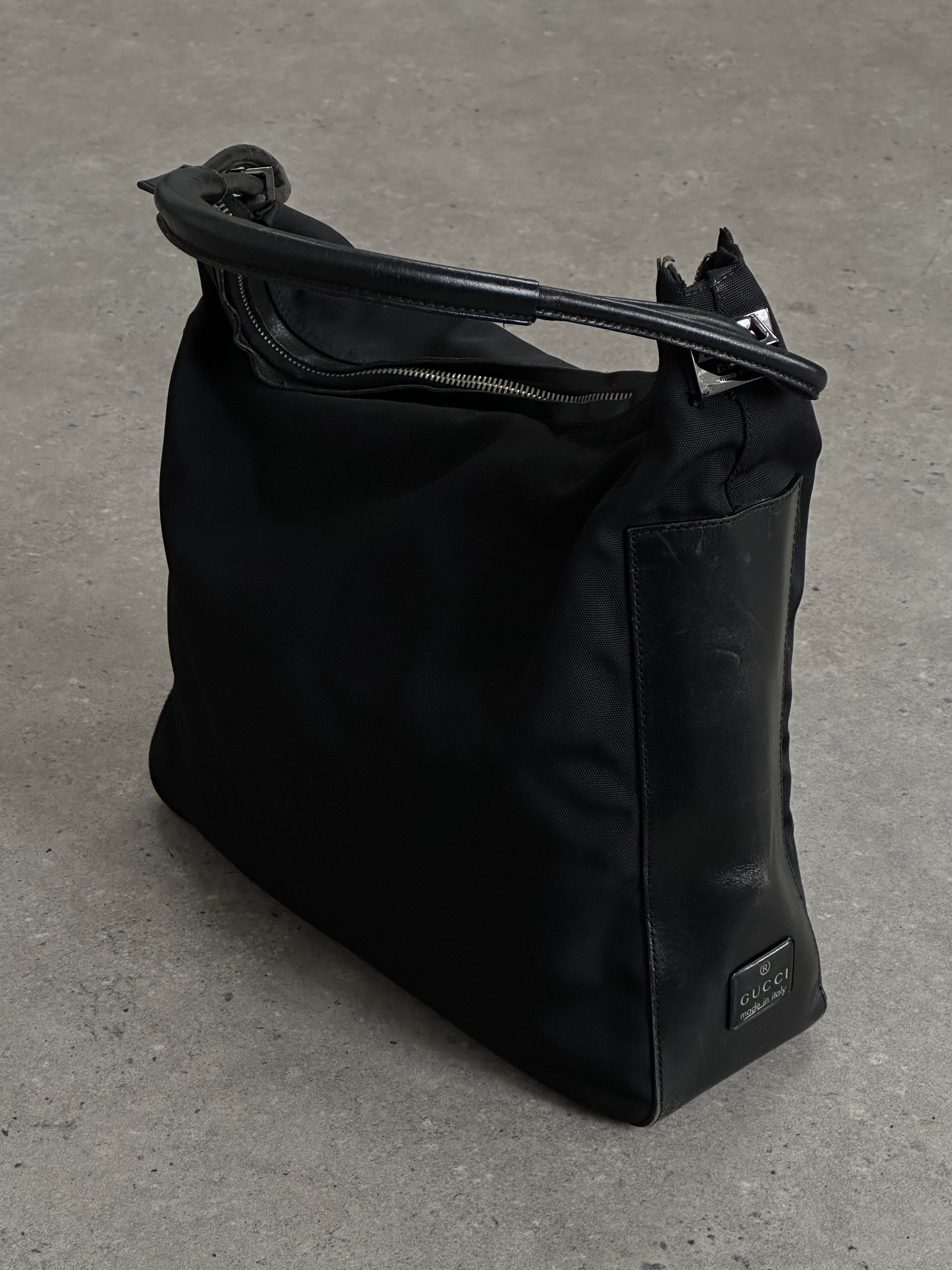 Gucci 1990s Tom Ford canvas leather hobo shoulder bag with stylish design and spacious interior.