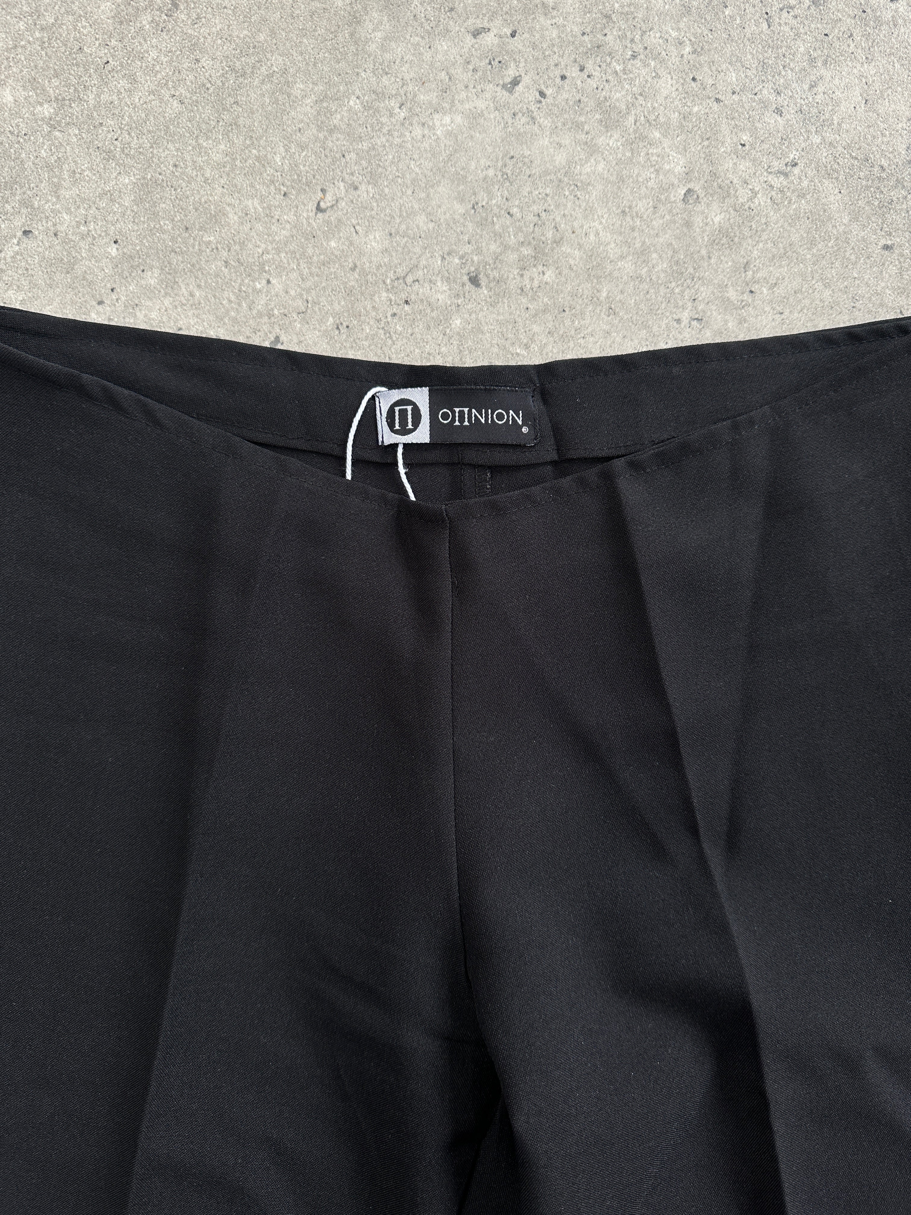 Vintage 1990s flared trousers in size W28, featuring classic retro style and high-waisted fit, displayed on a plain background.