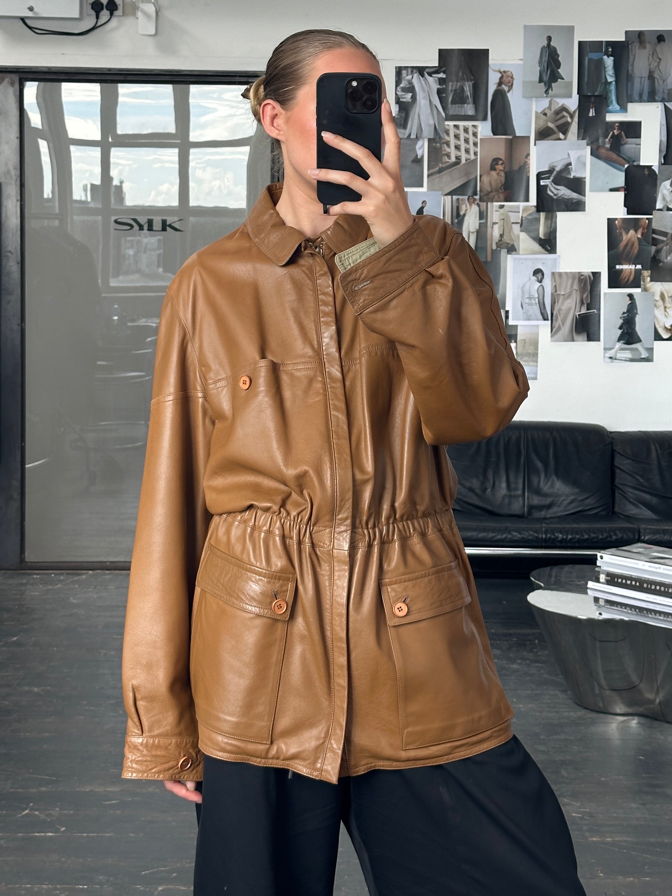Vintage Italian 1980s reversible leather jacket with cinched waist in size XL, featuring classic design and rich leather texture.