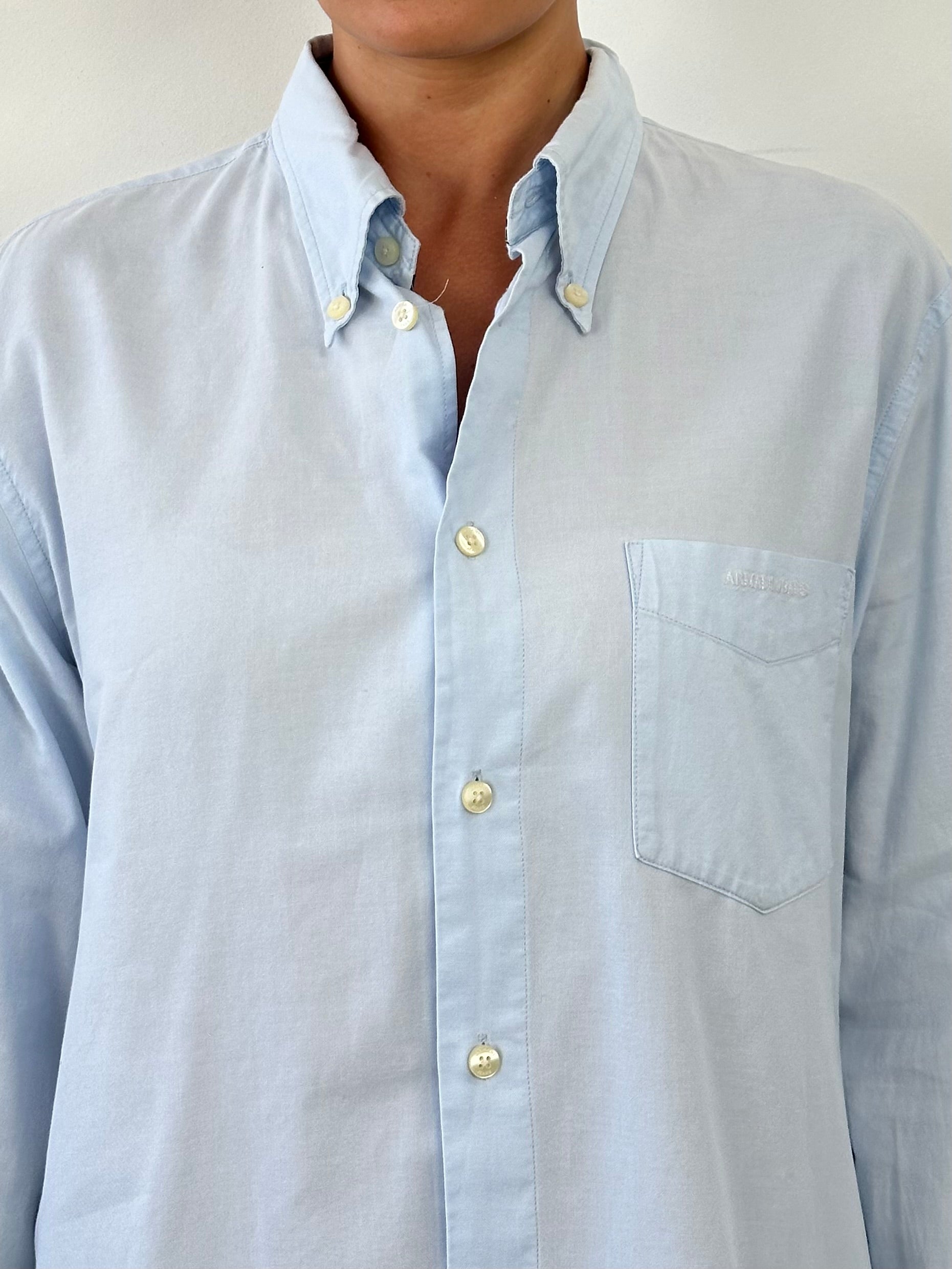 Armani Jeans pure cotton logo shirt in size L, featuring a classic design with the Armani logo on the chest, displayed on a hanger.