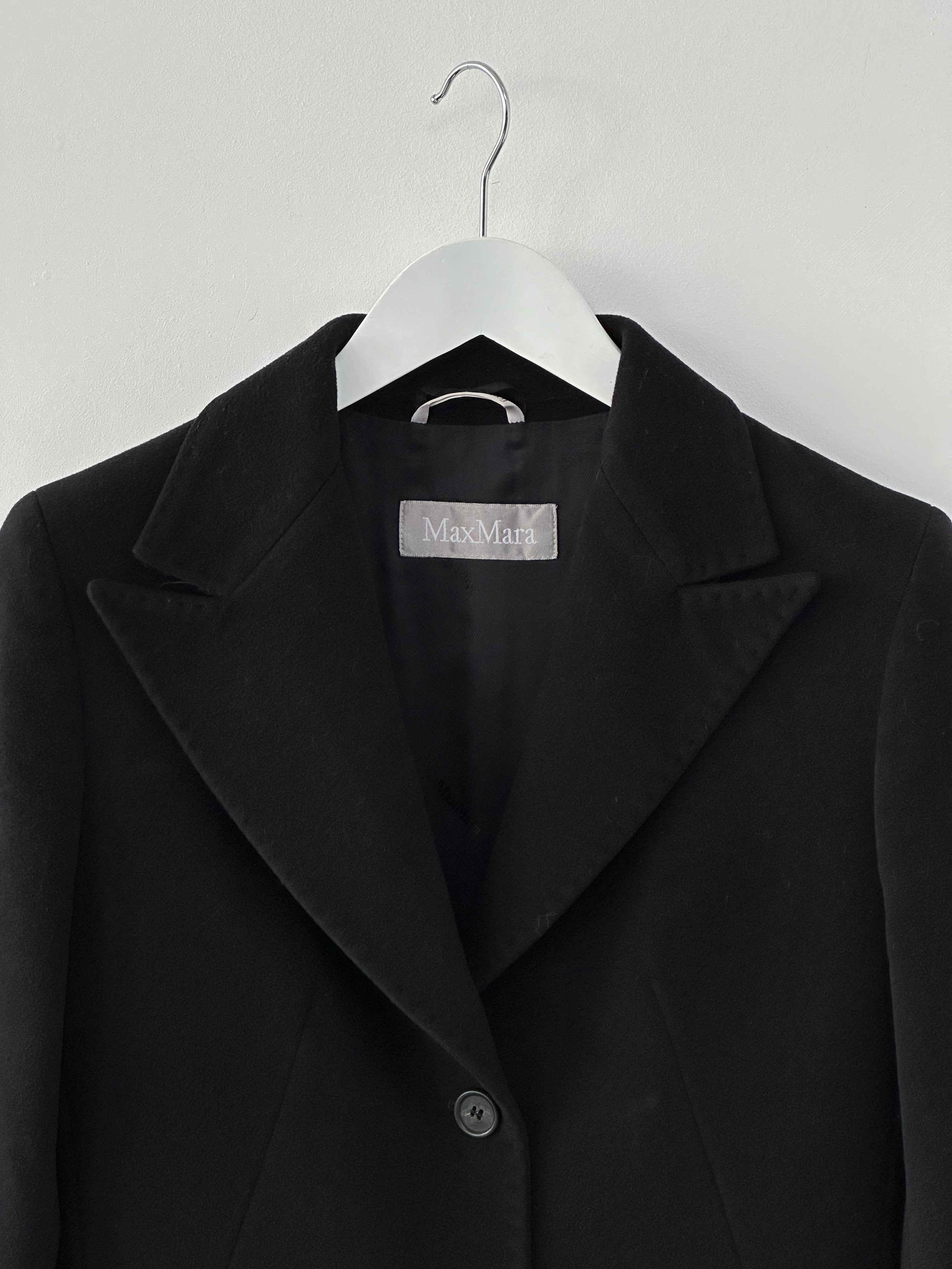 Max Mara pure wool single-breasted coat in size S, displayed on a hanger with a classic tailored design and neutral color.