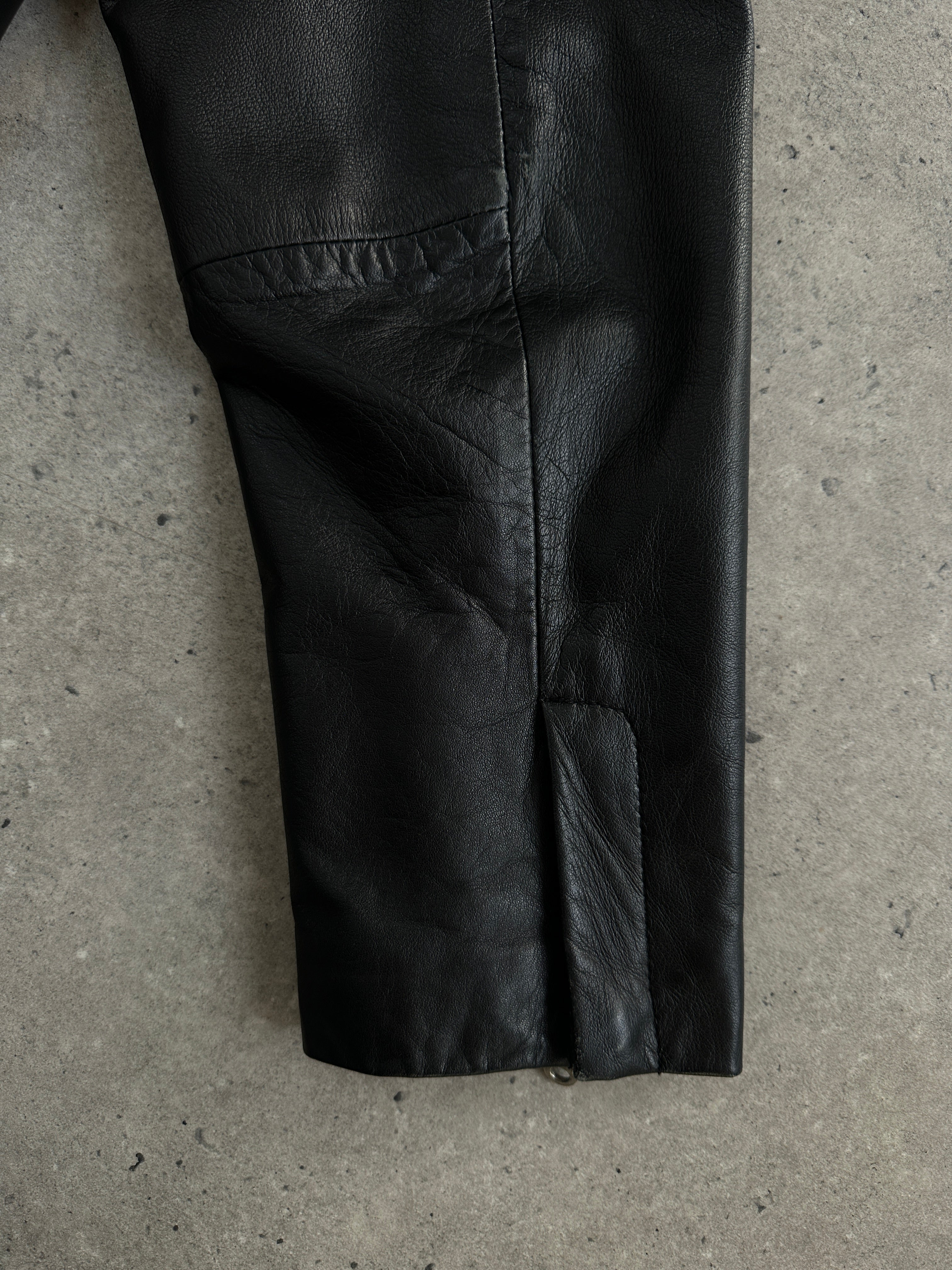 Vintage 2000s minimal high neck leather jacket in black, featuring a sleek design and tailored fit, front view.