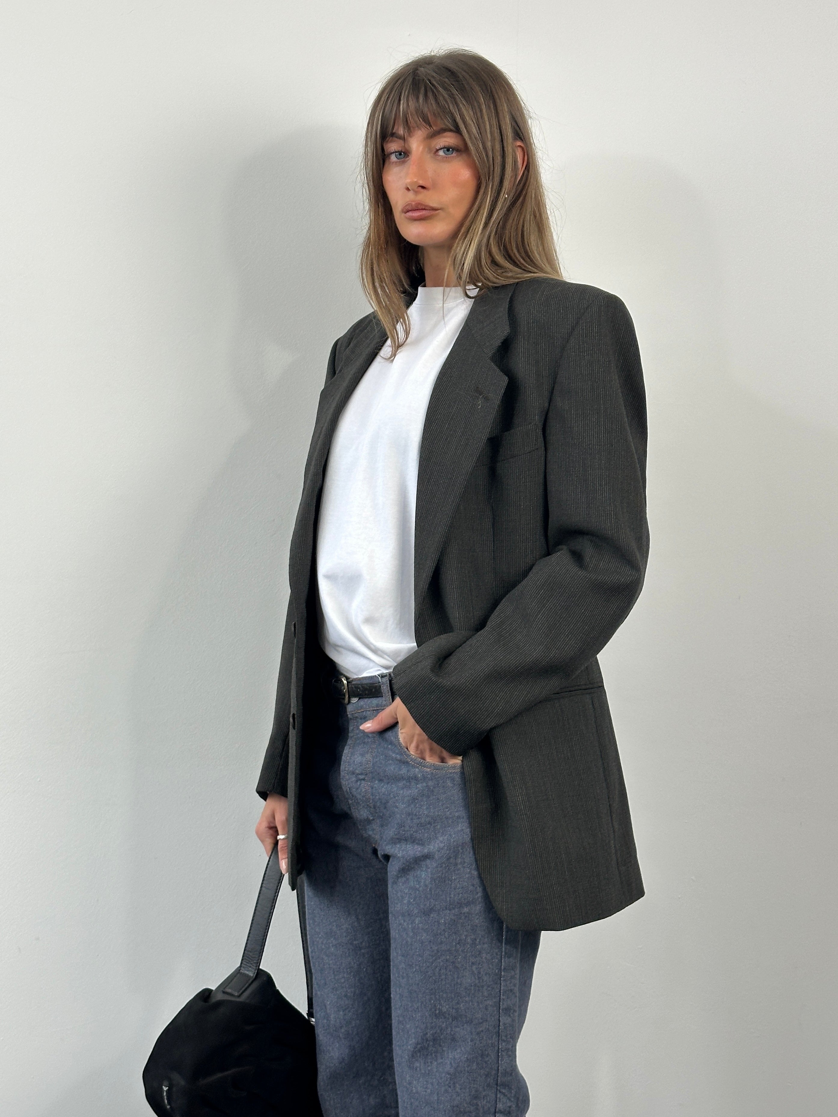 Yves Saint Laurent 1990s pure wool single-breasted blazer in size 40R/M, tailored with classic lapels and structured fit.