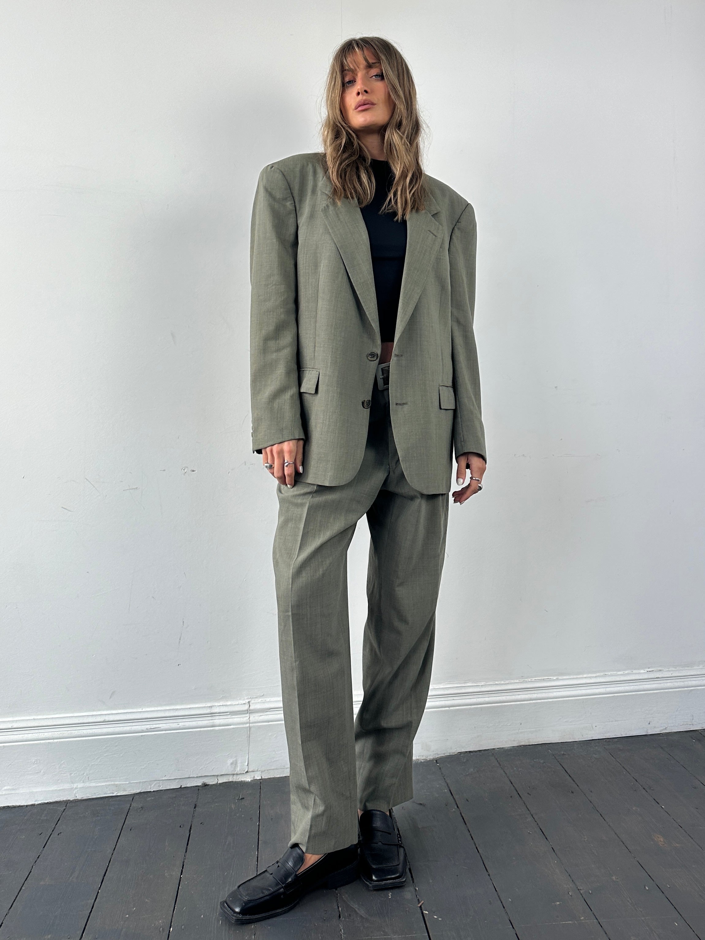 Christian Dior pure virgin wool single-breasted suit jumpsuit in size 42R/W32, shown in a tailored fit with lapel collar.
