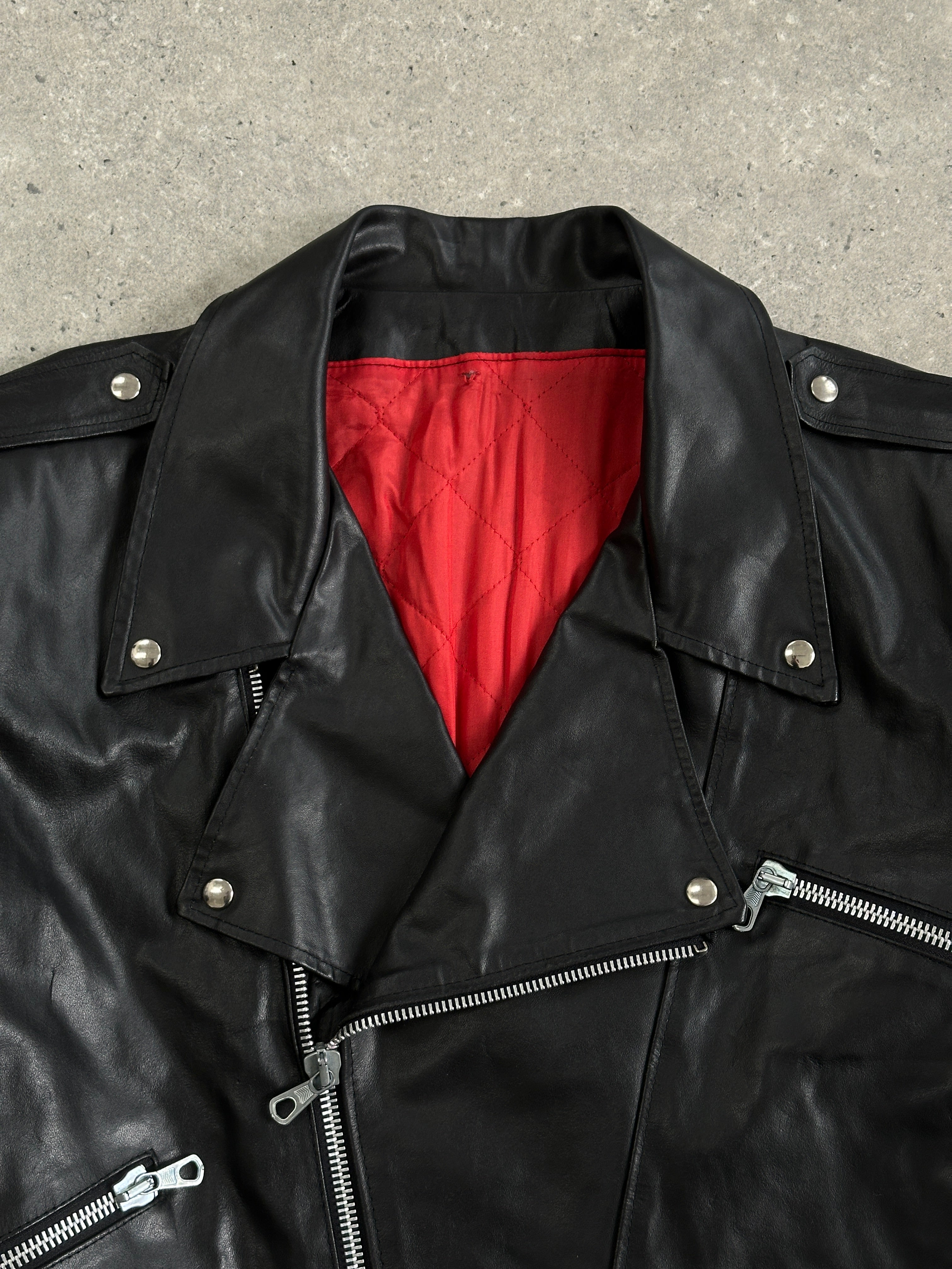 Vintage Italian vintage cropped leather biker jacket, size L, featuring classic zippers and structured design.