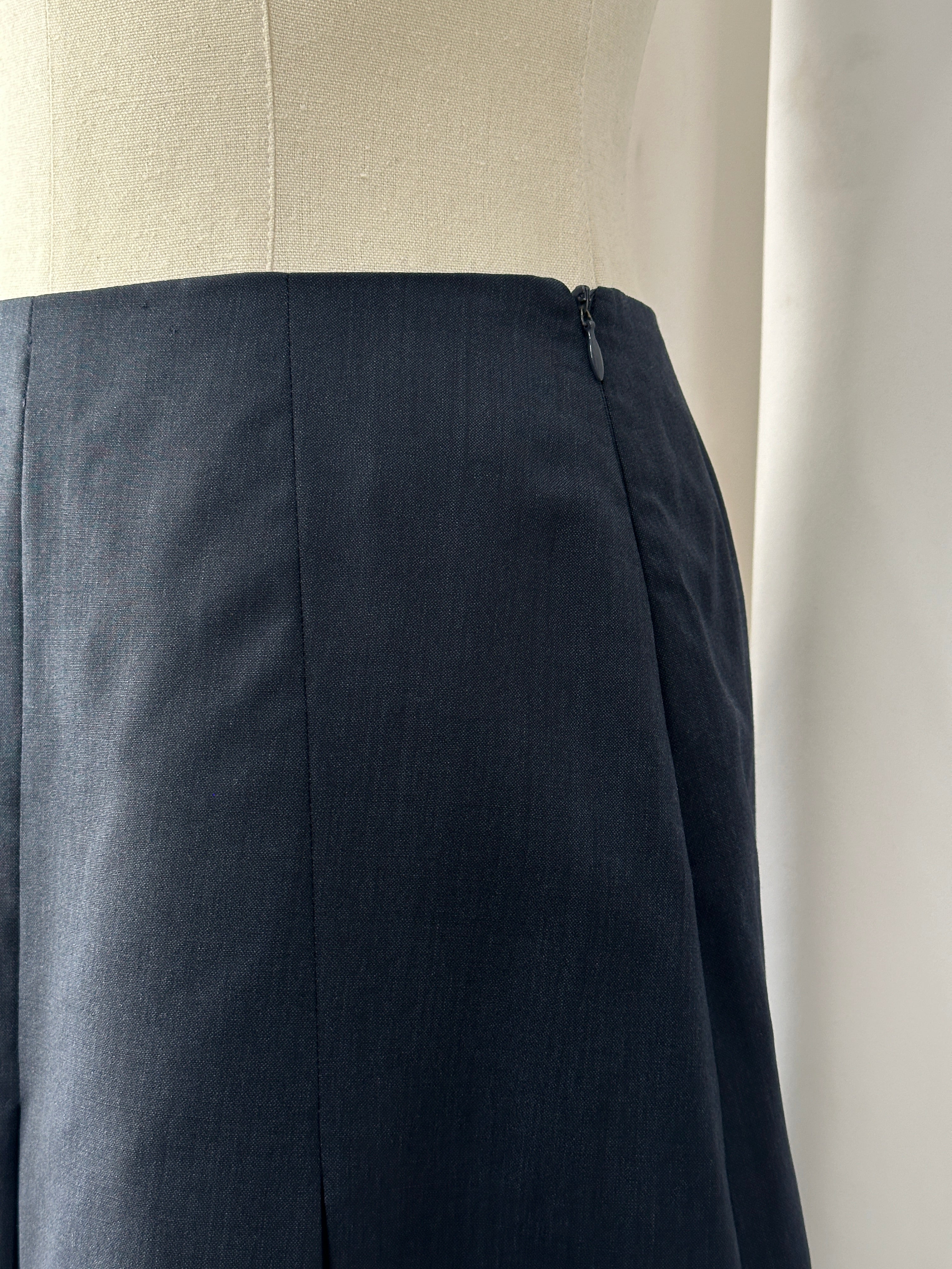 Vintage 1990s pure merino wool pleated mini skirt in classic style, shown in natural fabric and vintage design.