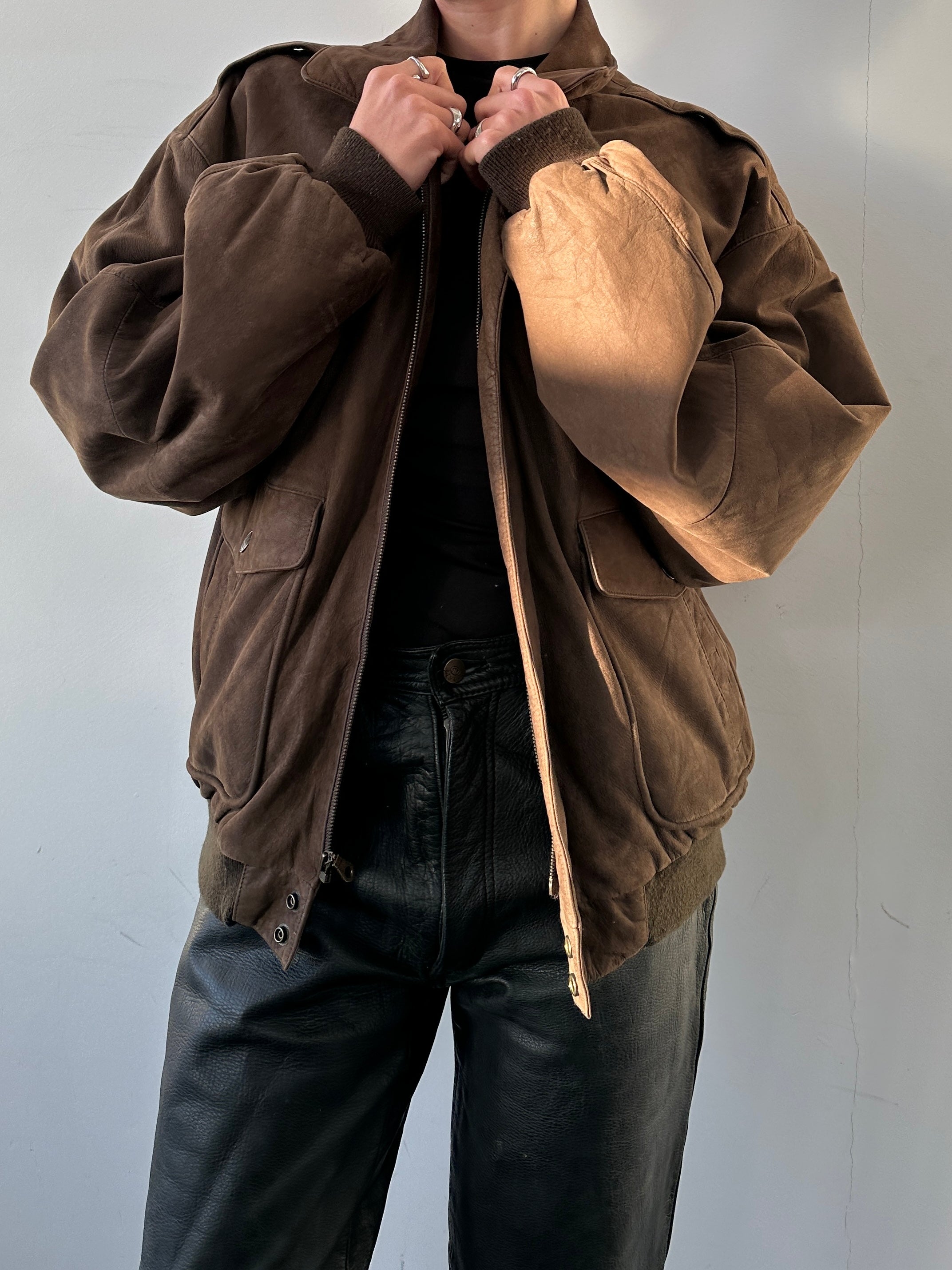Vintage Nubuck Leather Bomber Jacket in size L with classic design and soft texture, featuring a front zipper and ribbed cuffs.