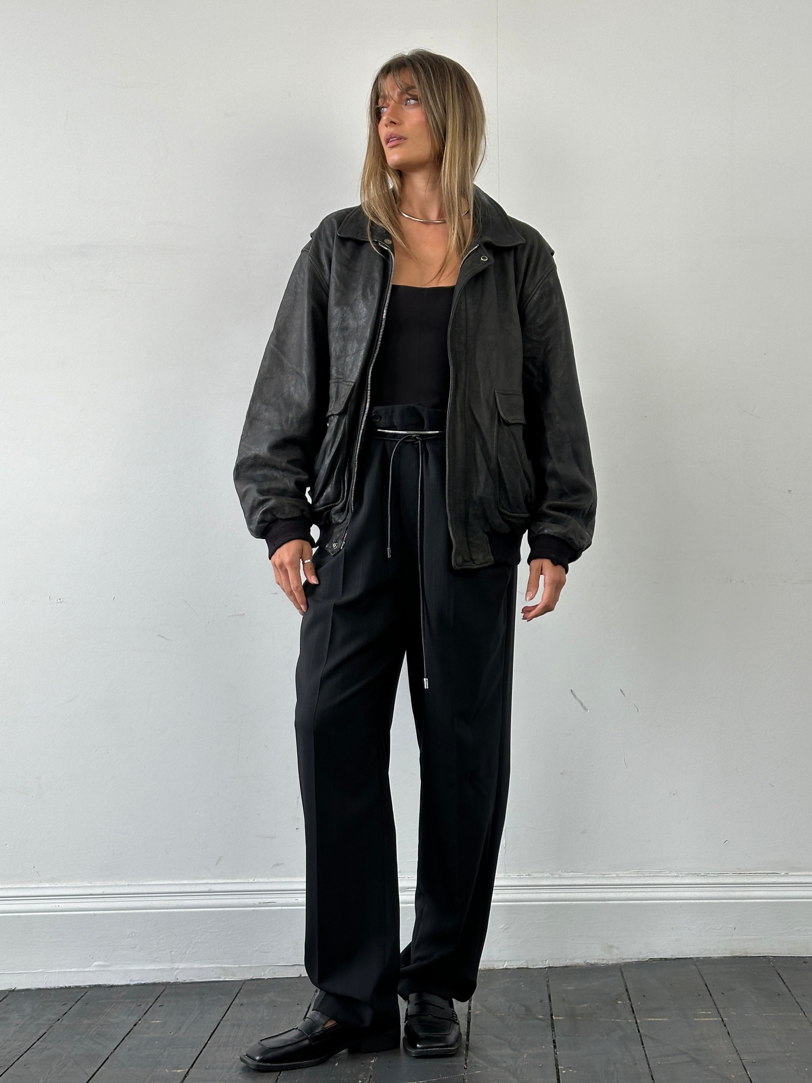 Italian vintage aged leather bomber jacket in XL with classic design, distressed leather texture, and ribbed collar and cuffs.
