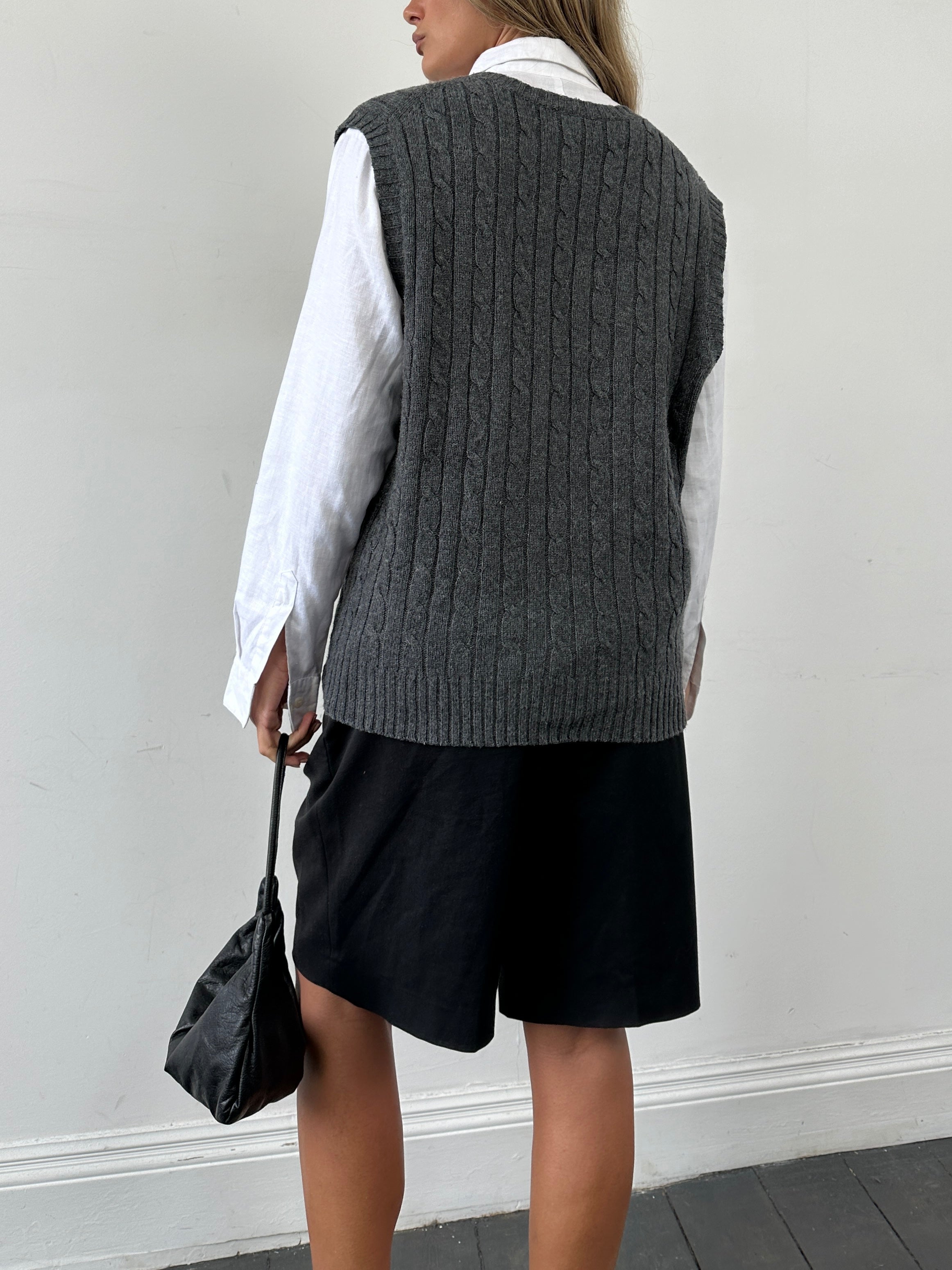 L.L.Bean lambswool cable knit sleeveless vest in size L/XL, featuring a textured pattern and ribbed neckline and hem.