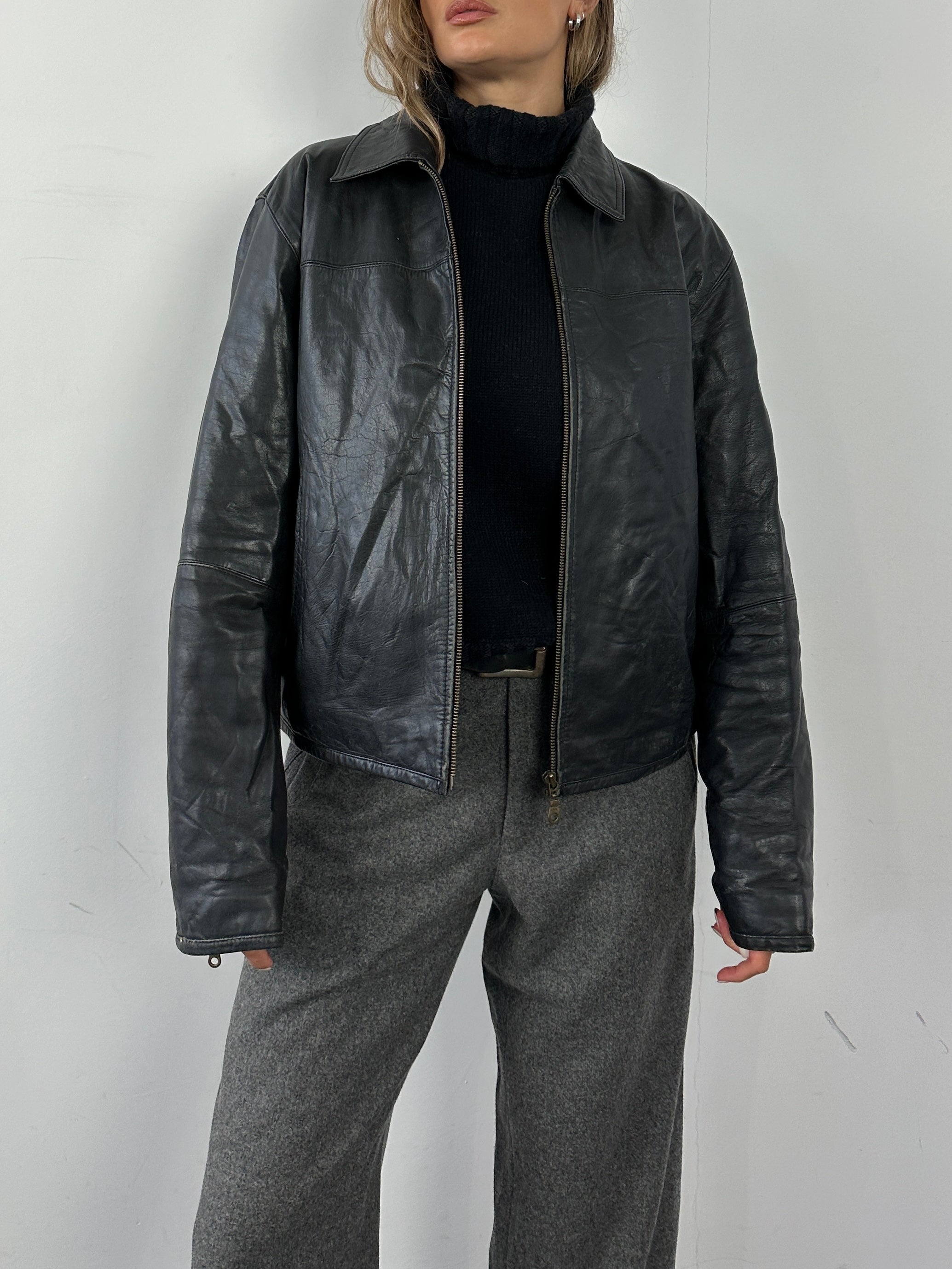Conbipel leather jacket in M/L size, featuring a sleek black design, smooth leather texture, and classic collar detail.