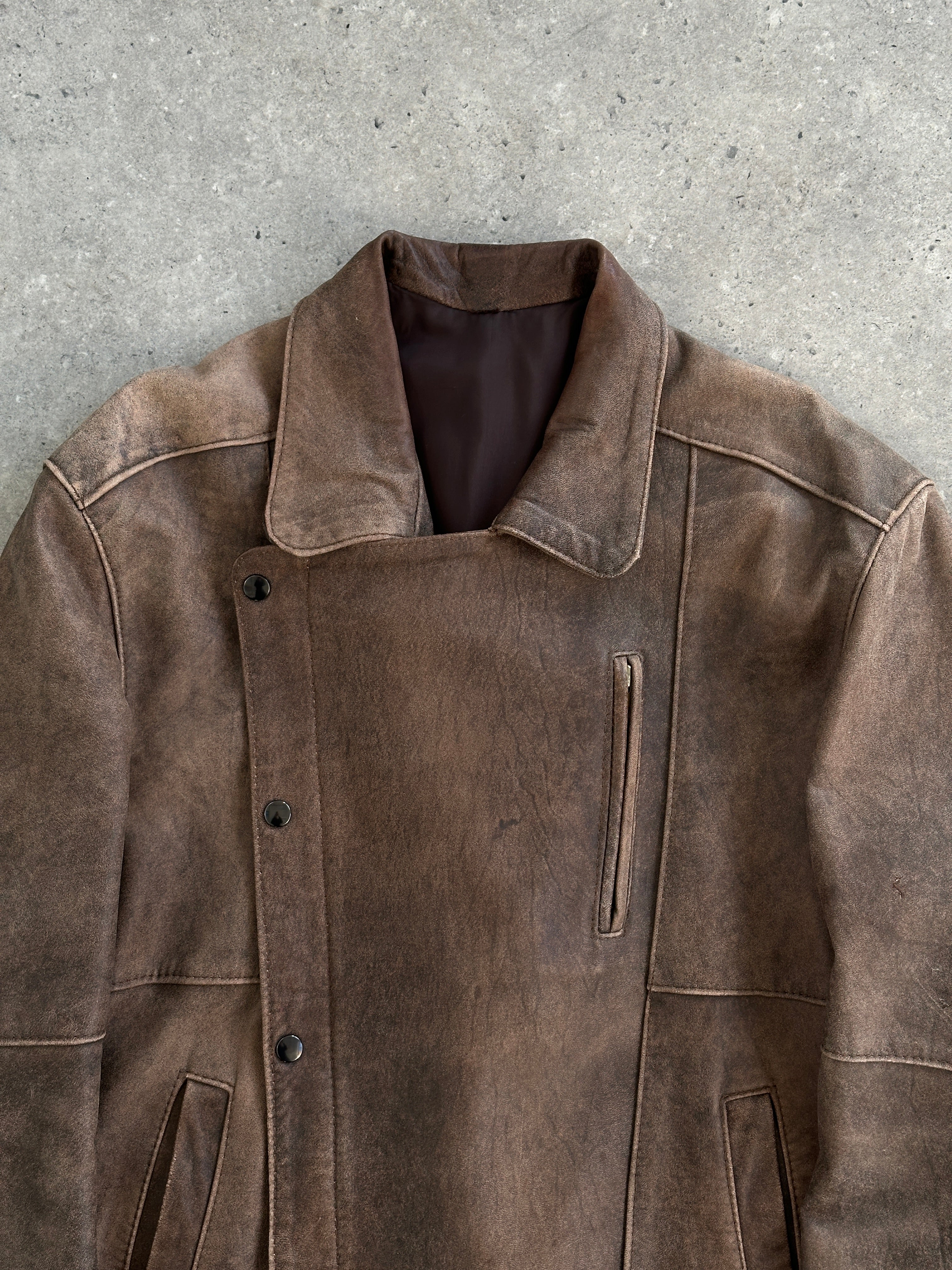 Vintage British vintage aged leather biker jacket, M/L size, showing rugged texture and classic design.
