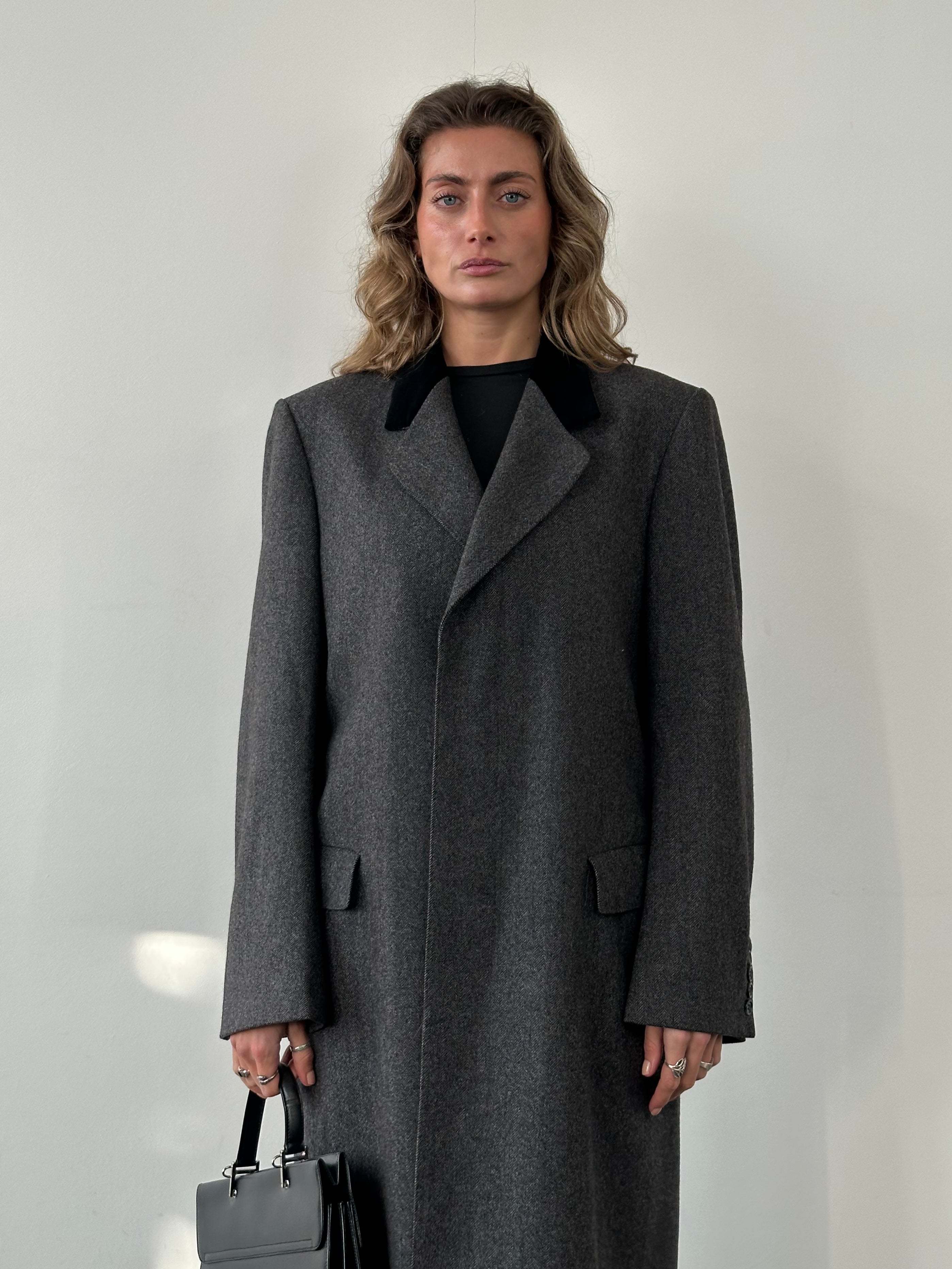 Christian Dior pure wool single-breasted coat in size L/XL displayed on a hanger, showcasing its tailored fit and classic design.