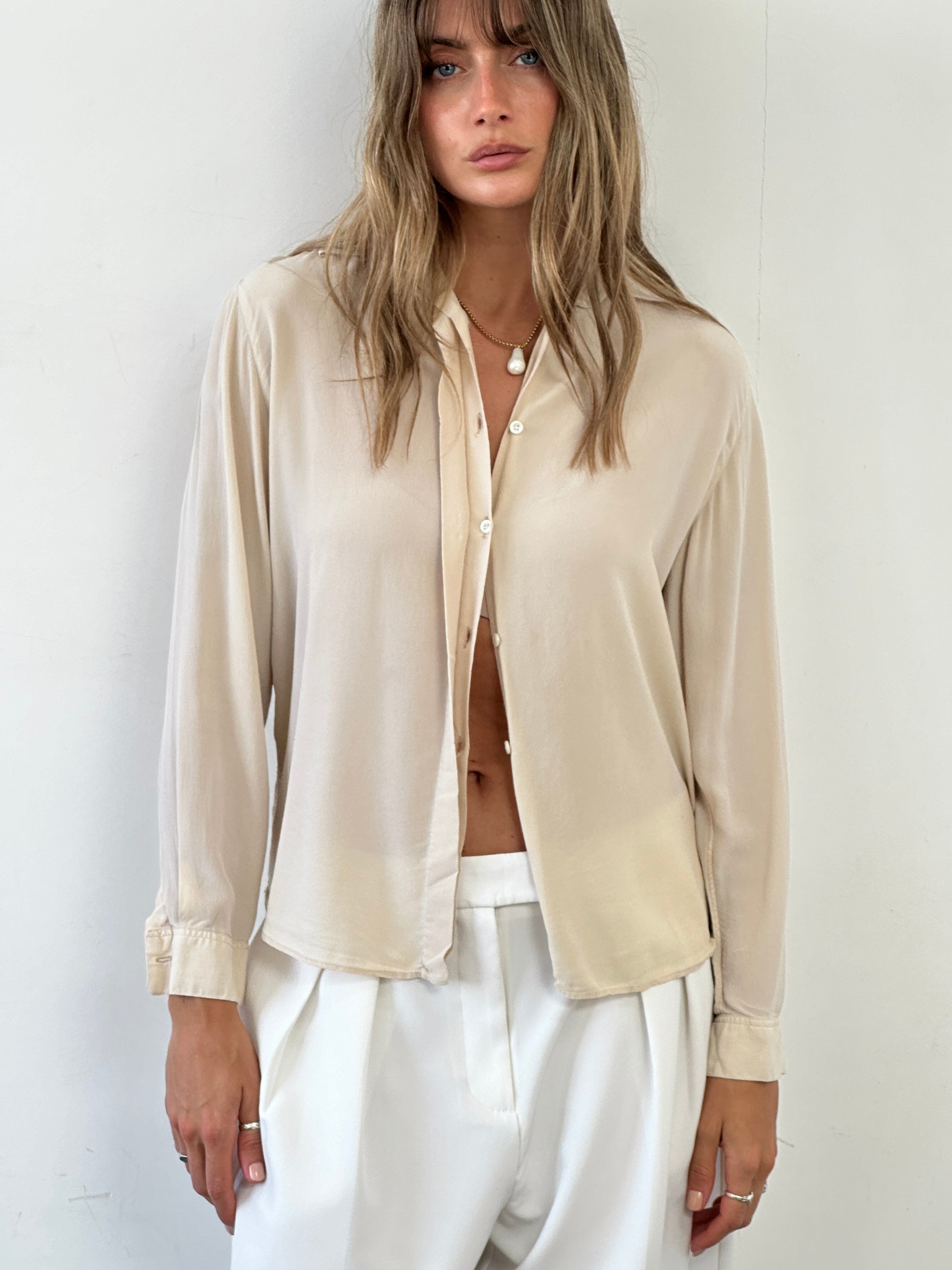 Vintage Italian vintage pure silk blouse with concealed placket, short sleeves, and elegant design, size small.