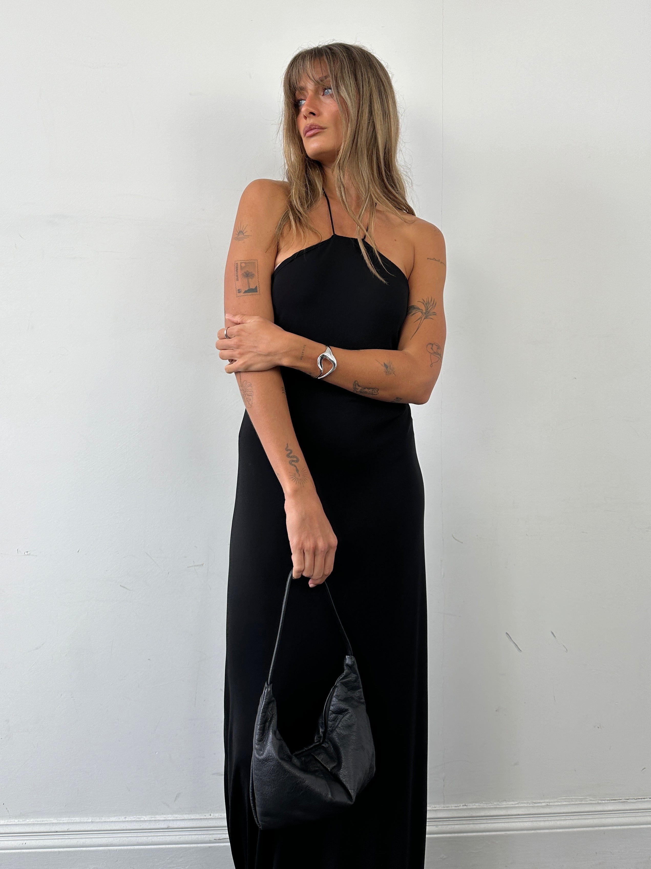 MAX & Co leather crescent shoulder bag with adjustable strap and sleek design, featuring a smooth finish and minimalist style.