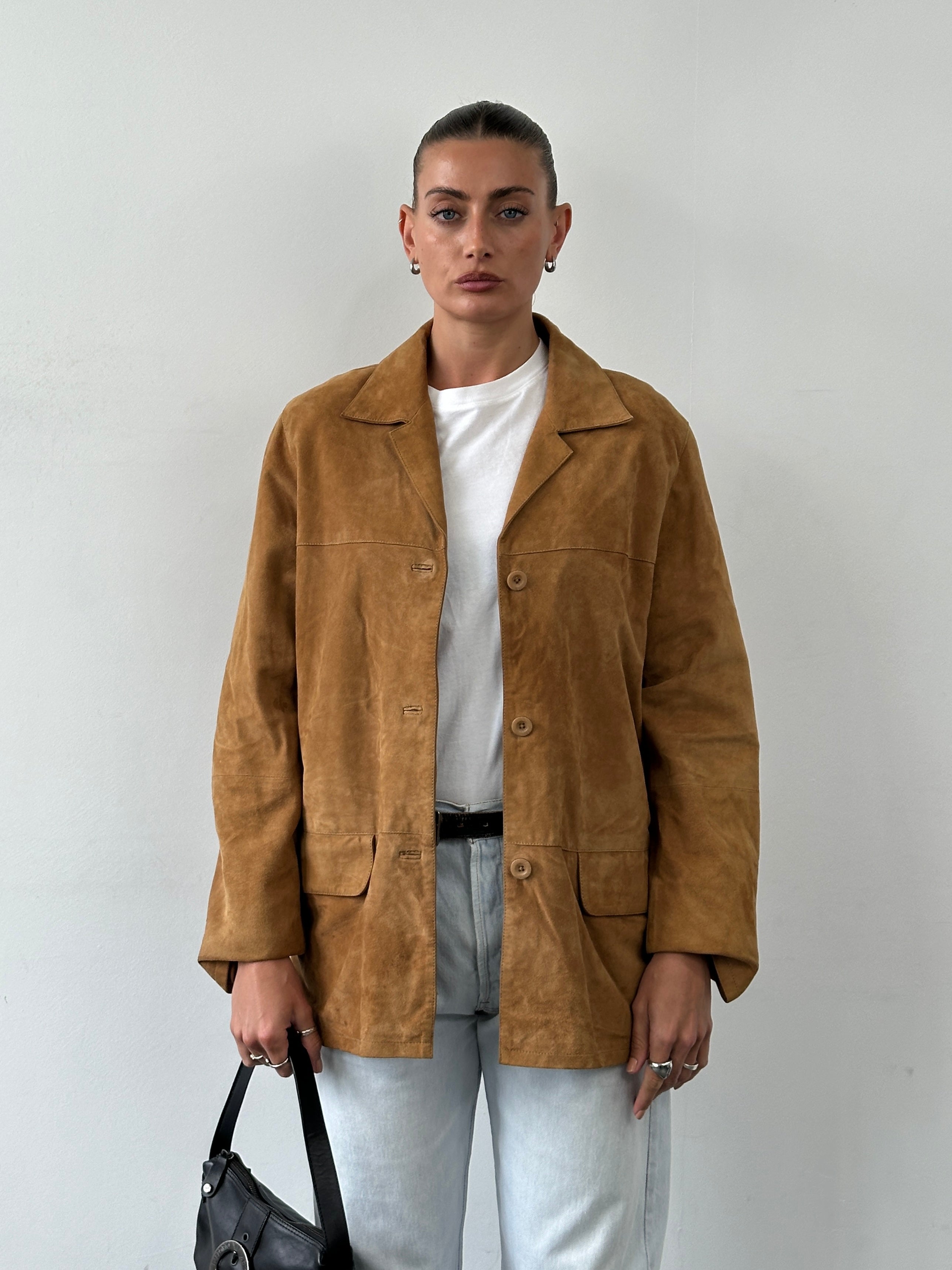 Vintage suede leather jacket in medium/large size, featuring classic design and textured suede material.