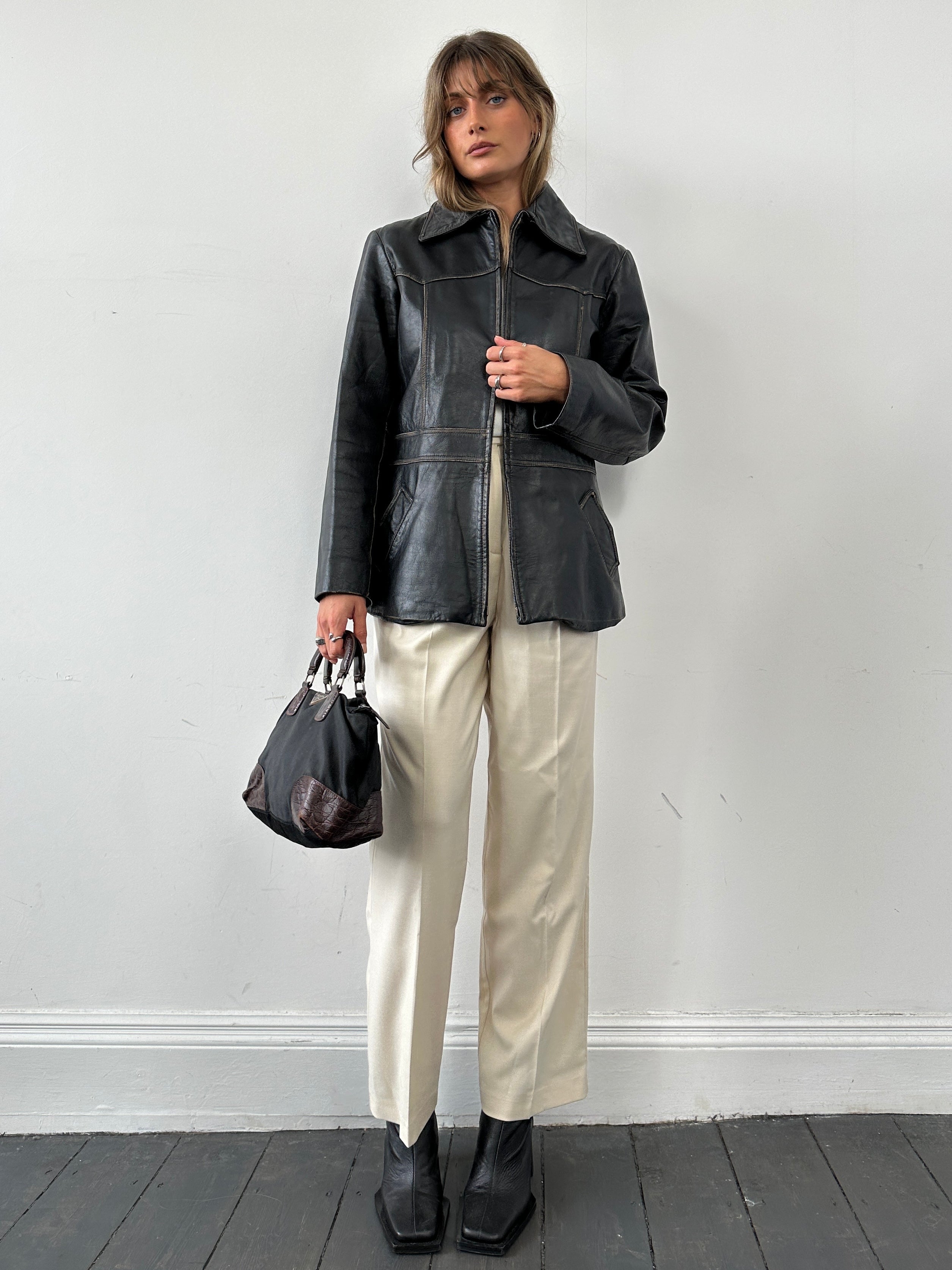 Conbipel double zip waisted leather jacket in black, featuring a fitted design and zippered front for a stylish look.