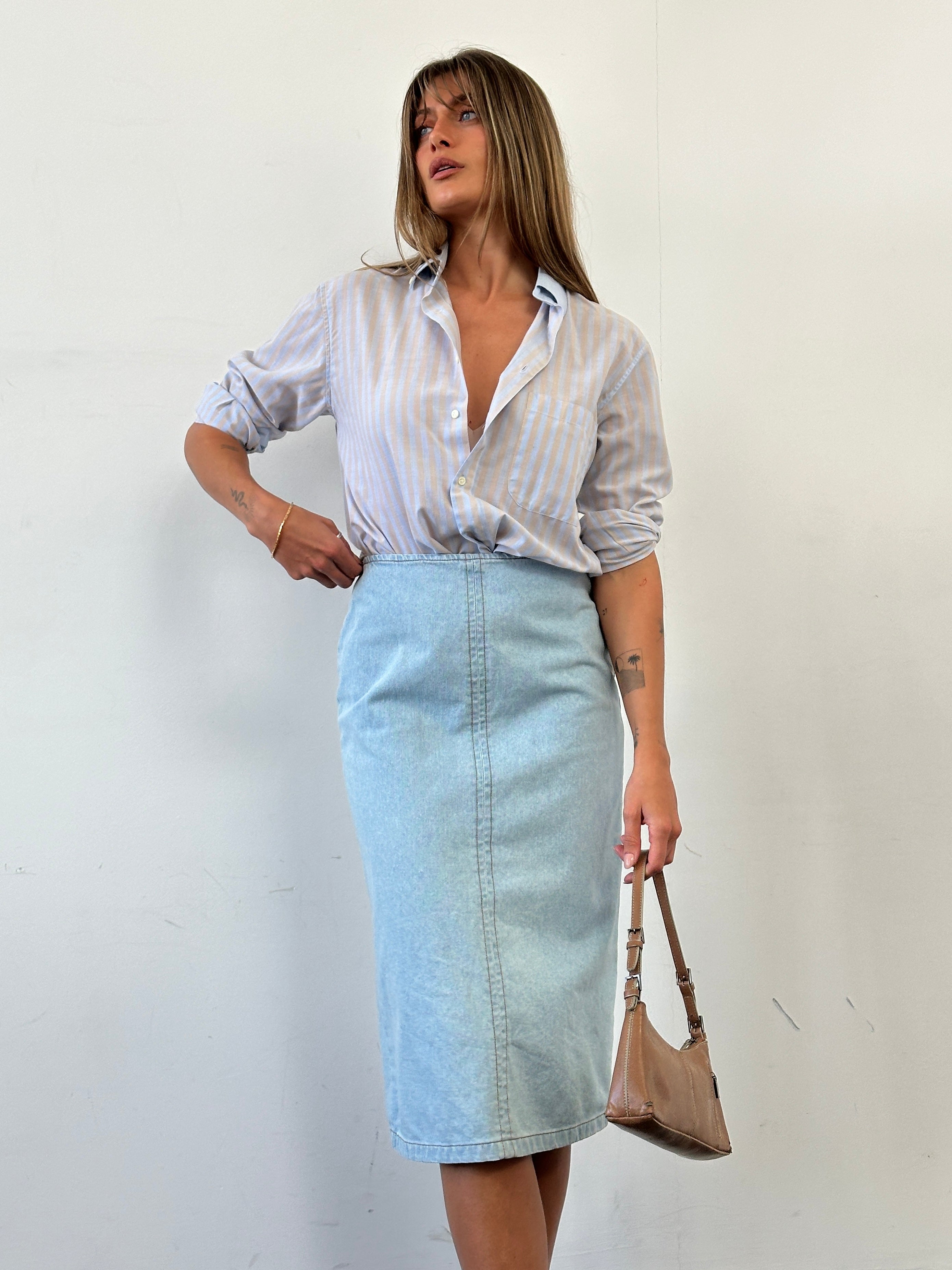 Max Mara pure cotton denim midi skirt in W26 laid flat, showcasing classic blue fabric and clean design.