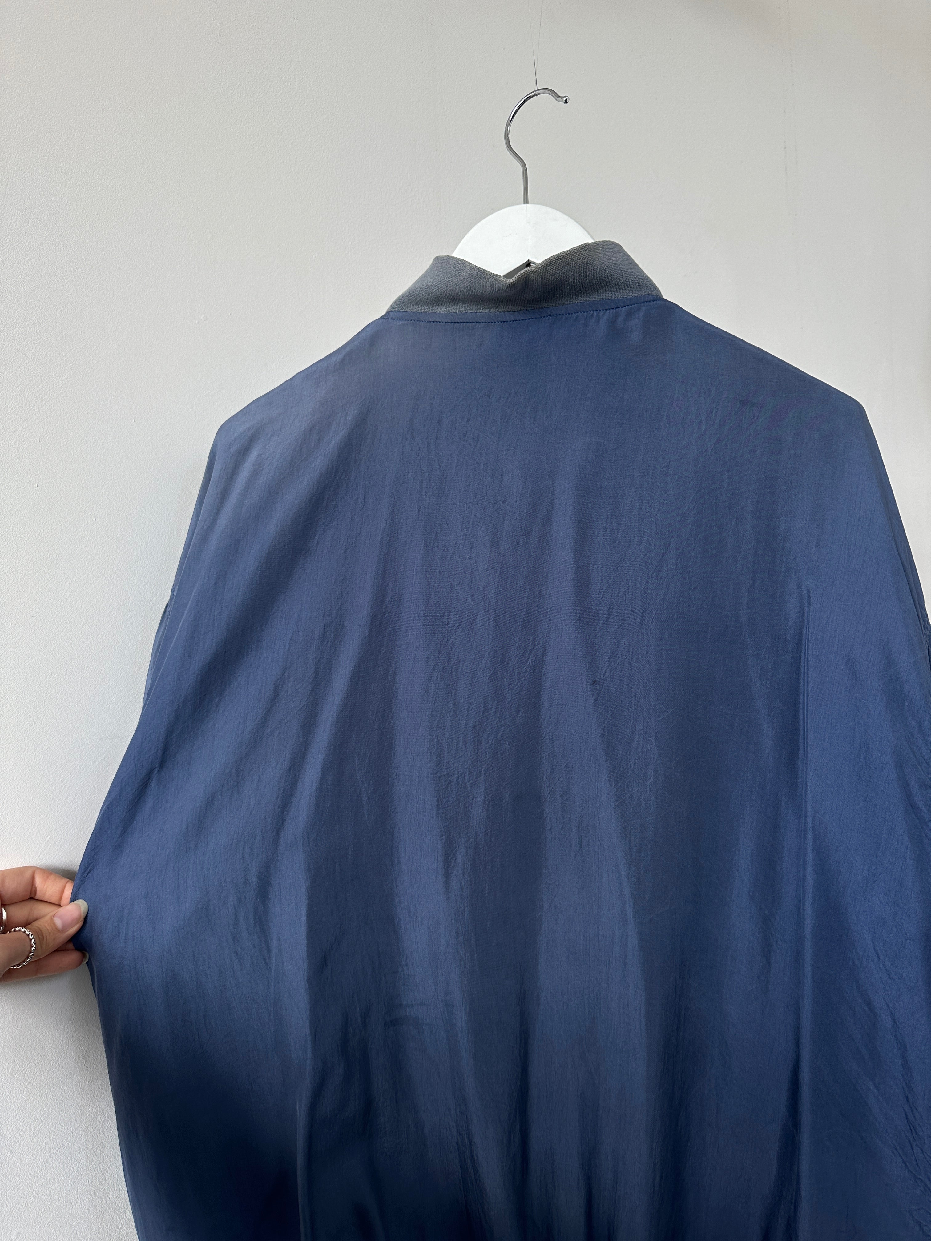 Vintage pure silk bomber jacket in XL with a classic design and smooth fabric, featuring a stylish collar and zipper details.