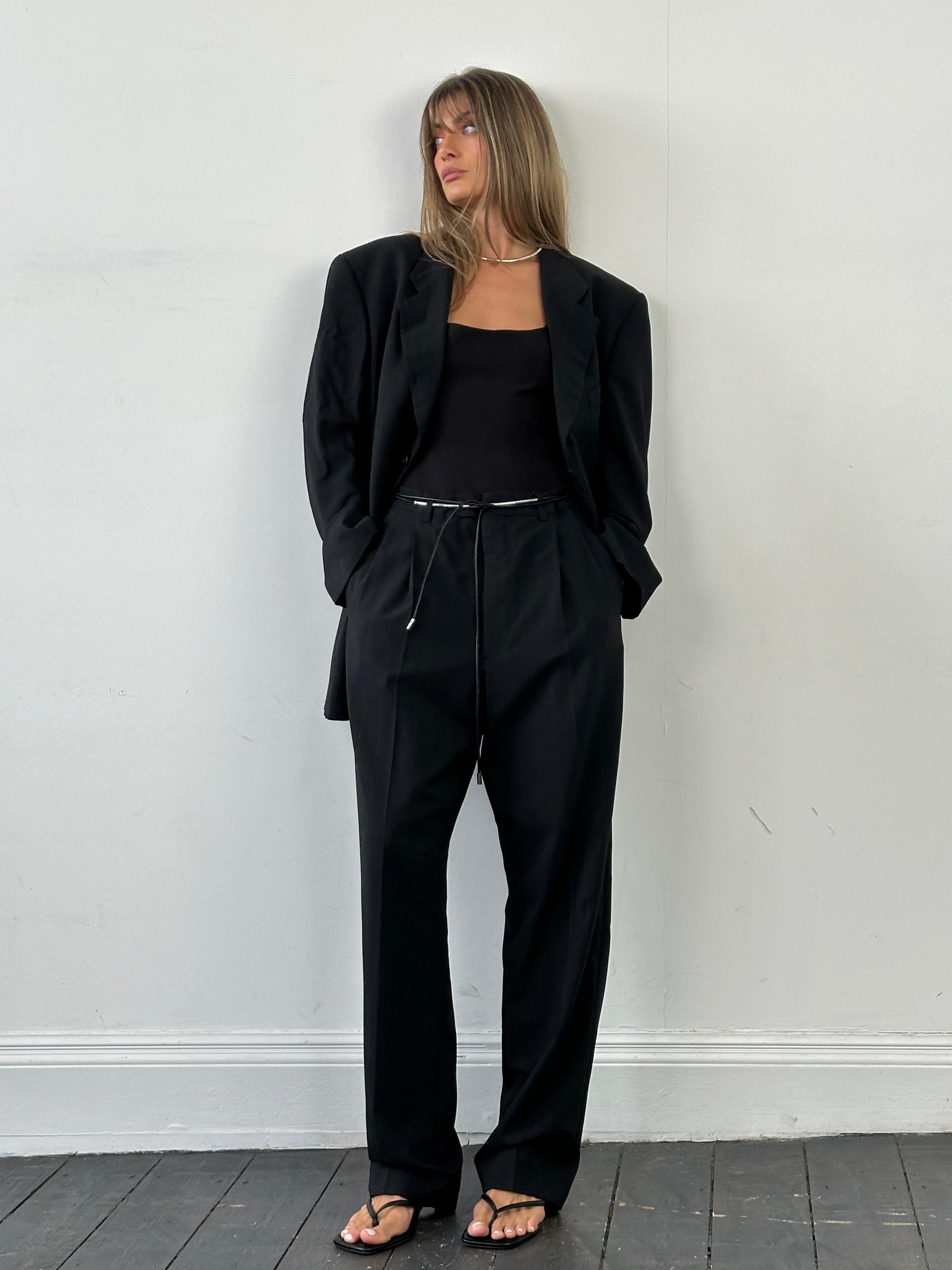 Giorgio Armani Le Collezioni pinstripe wool single-breasted suit in size 46R/W36, displayed as a stylish jumpsuit in a formal setting.