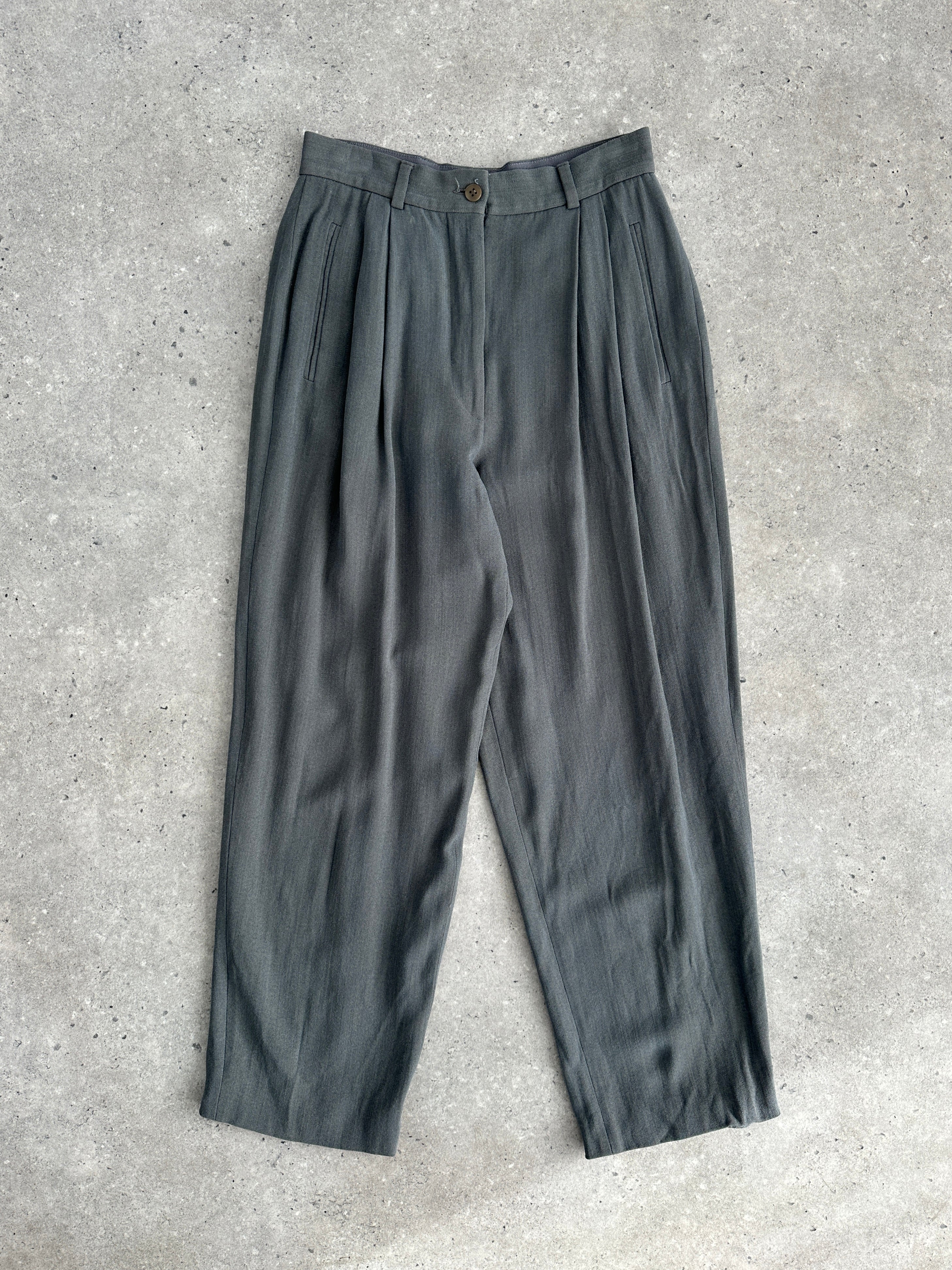 Giorgio Armani high-waisted tapered leg pleated trousers in neutral fabric, shown on a model against a plain background.
