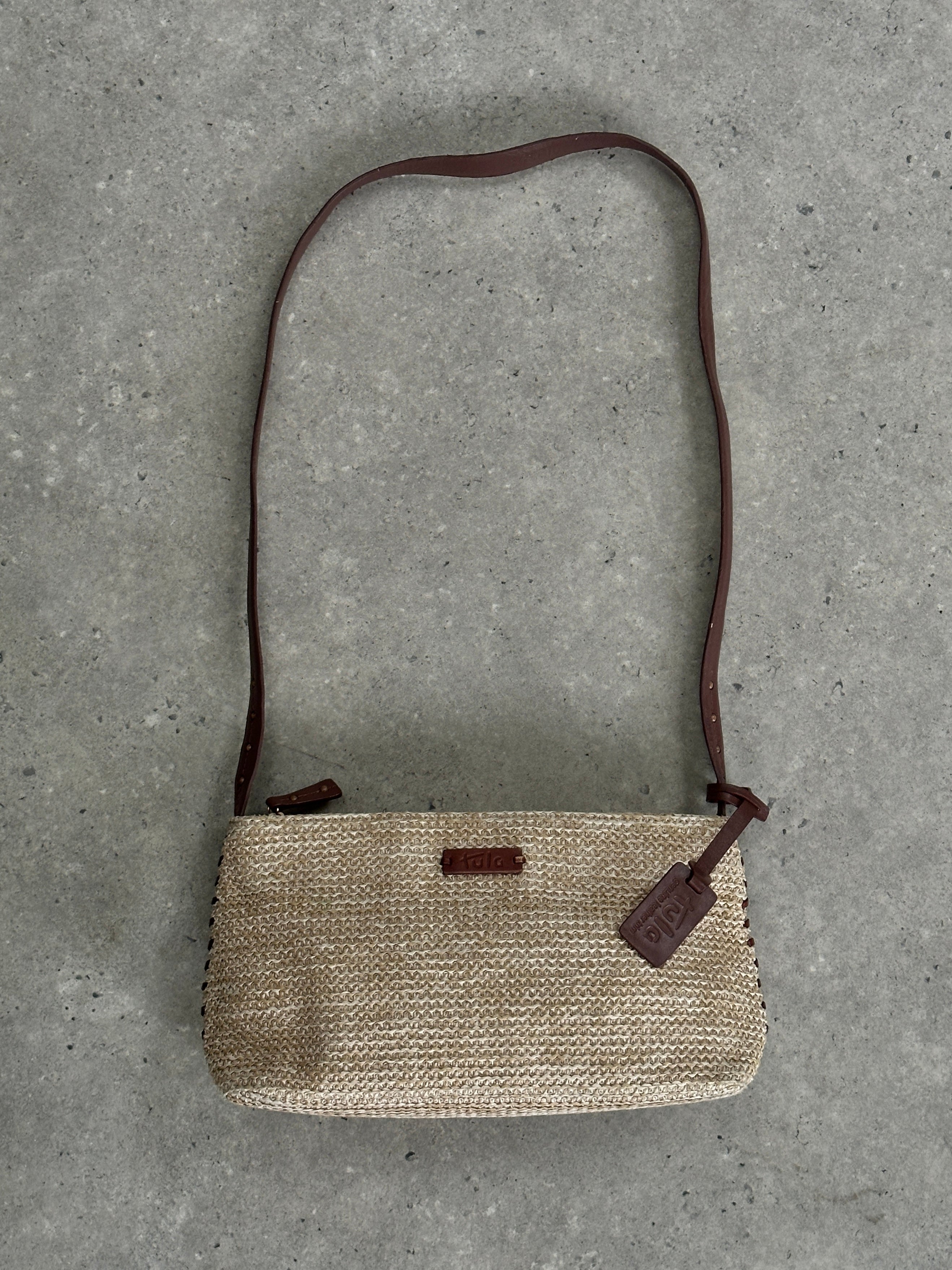 Vintage raffia crossbody bag with woven texture and adjustable strap, stylish and lightweight for casual wear.