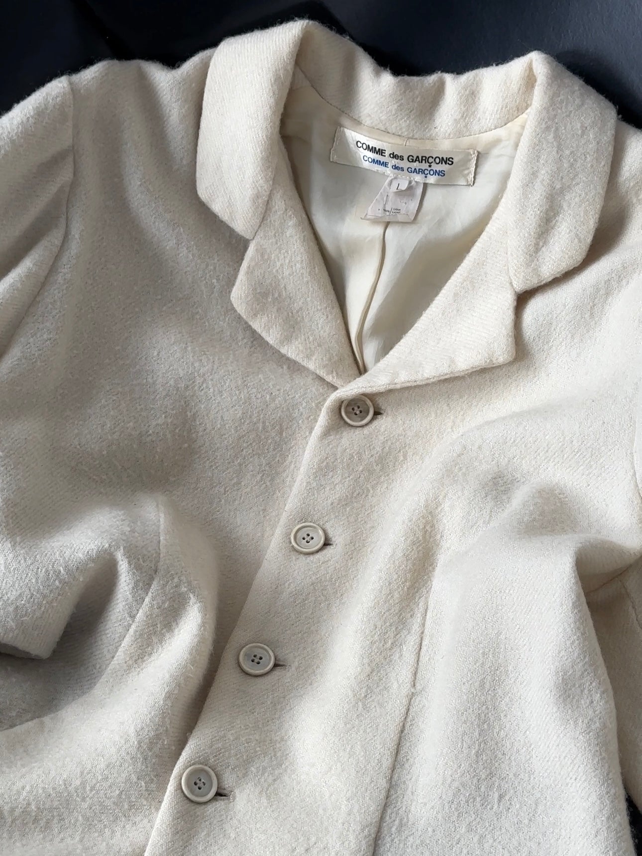 Comme des Garçons 90s unlined waterfall pure wool coat in beige, front view showing draped open collar and relaxed fit.