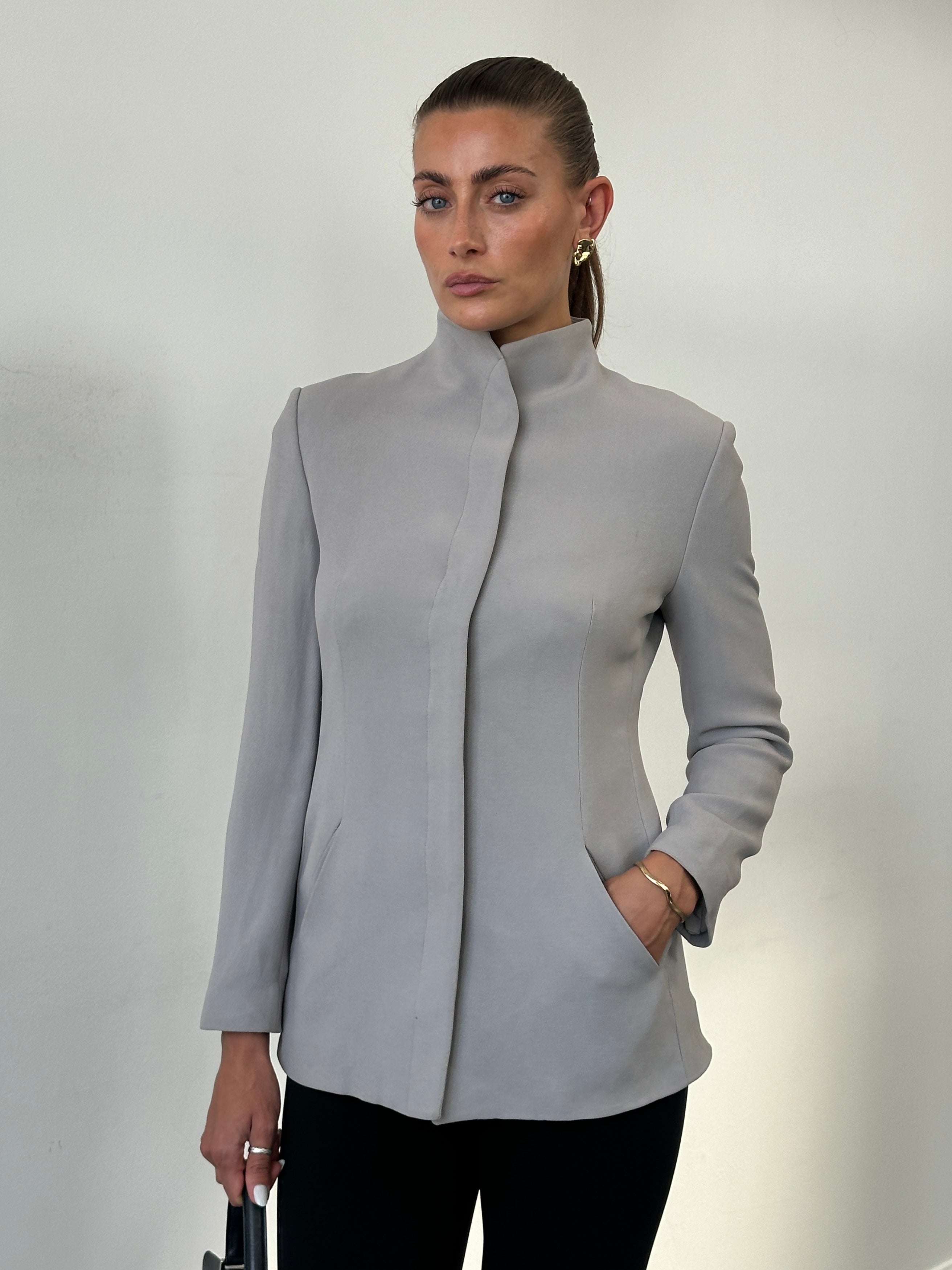 Emporio Armani high neck fitted blazer jacket in sleek, minimal design, shown in a close-up view highlighting the tailored fit.