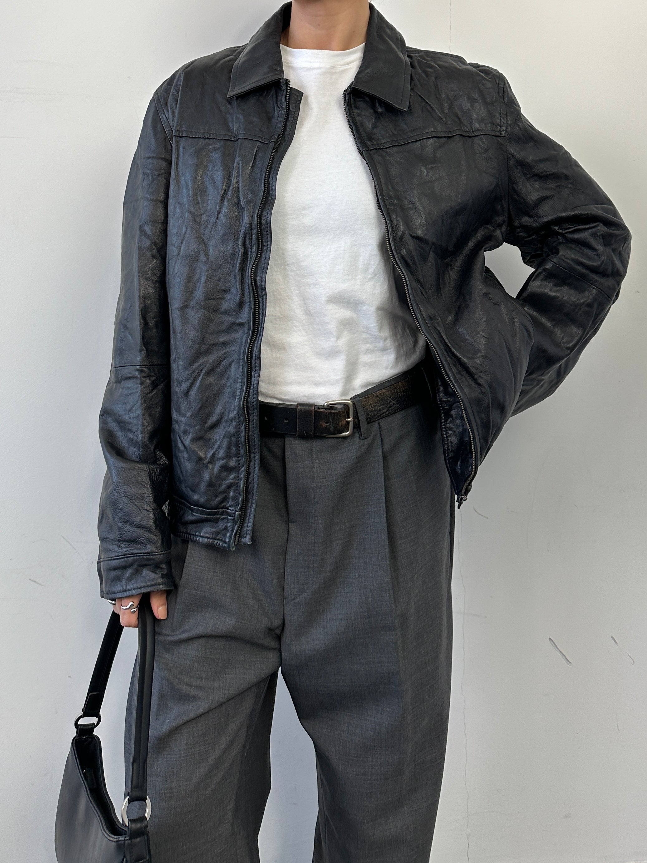 Vintage men's leather jacket with zip-up front, classic distressed leather, and stylish collar detail.