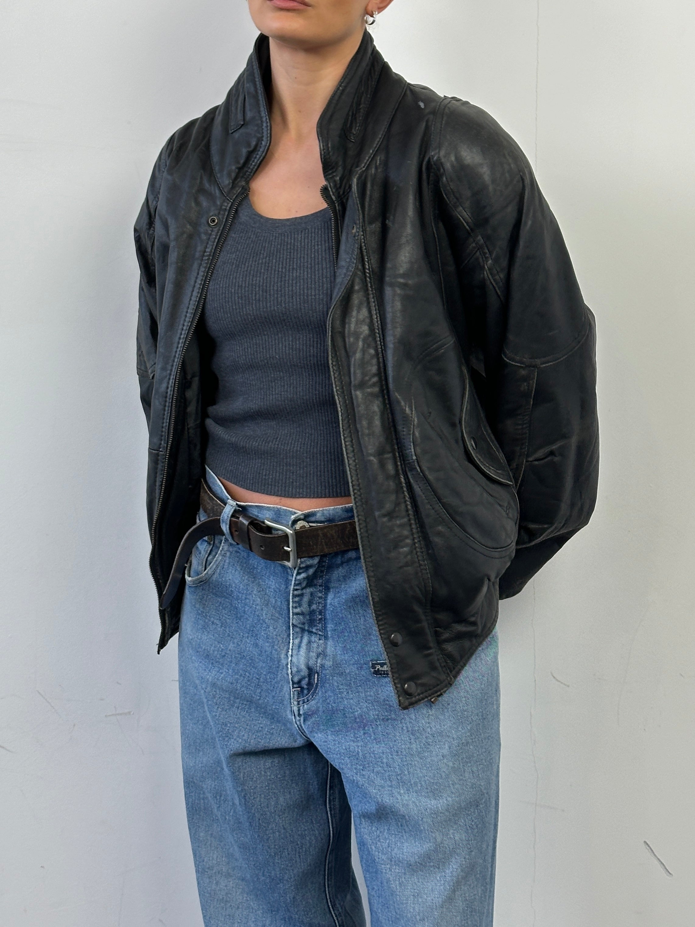 Vintage leather bomber jacket in size M featuring classic design, smooth leather, and stylish ribbed cuffs and collar.