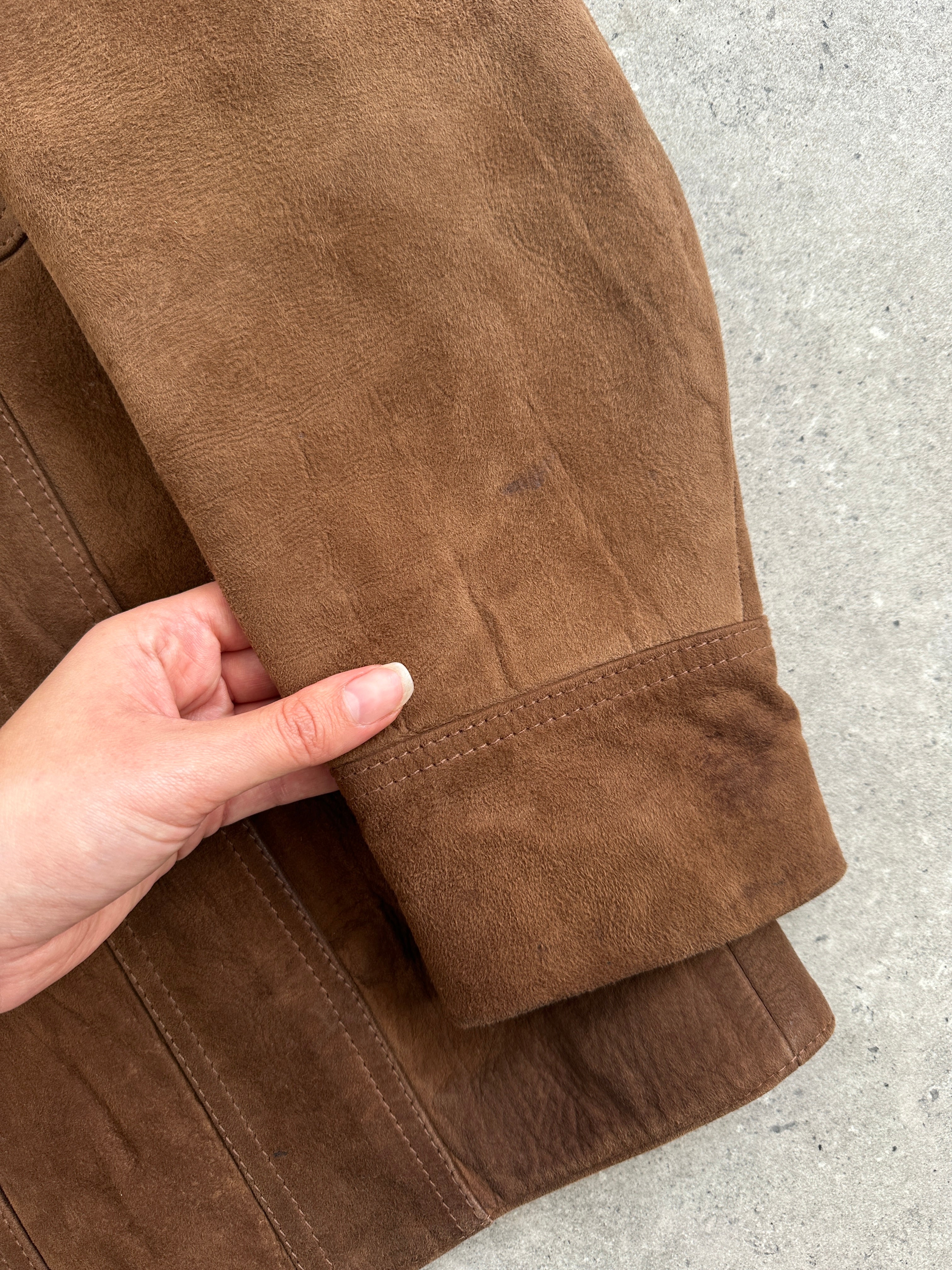 Vintage British 70s suede leather trucker jacket in size large, featuring classic retro style and rugged suede texture.