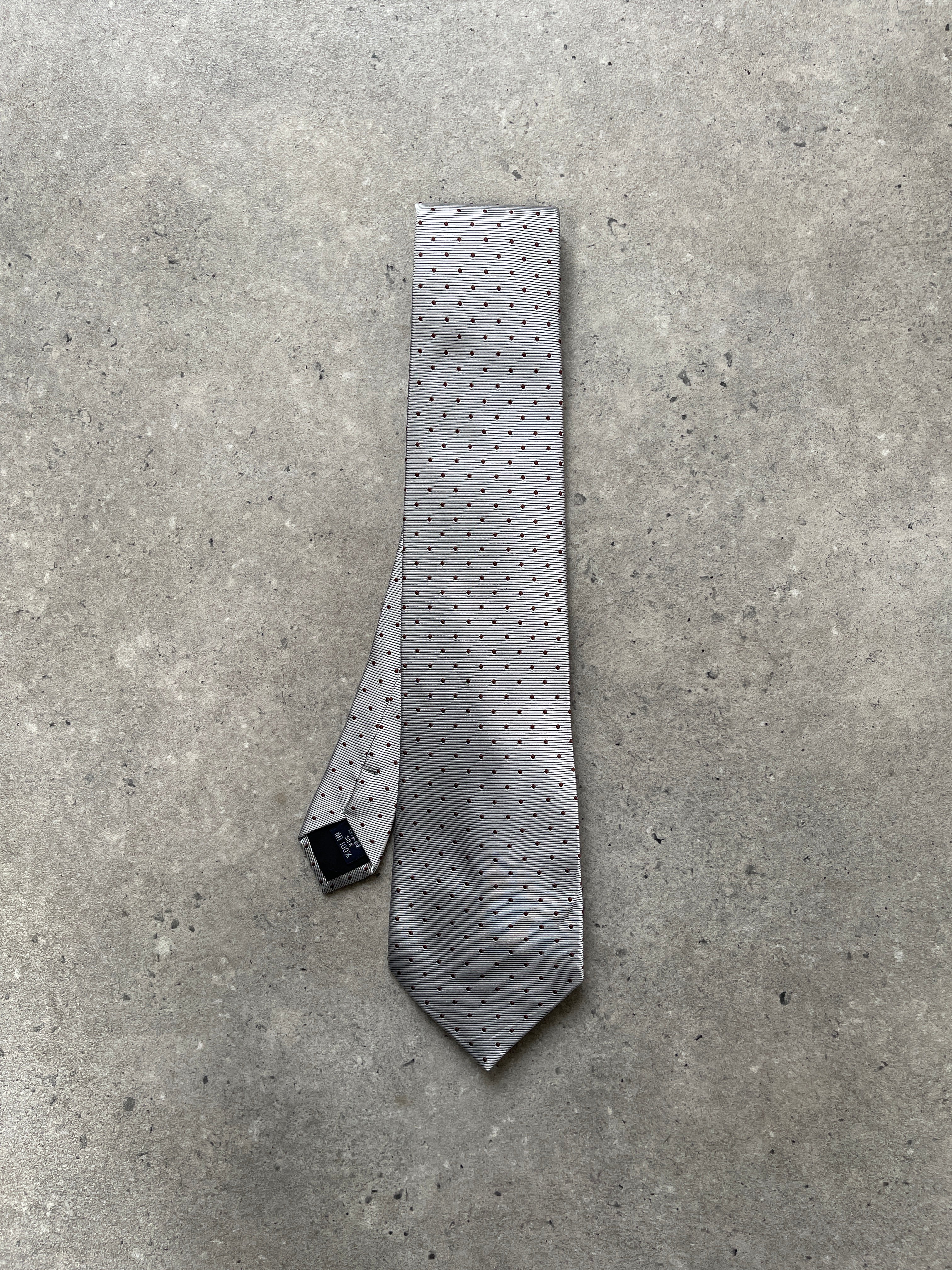 Burberry London 2000s pure silk polka dot tie displayed flat, showcasing its classic black and white polka dot pattern.