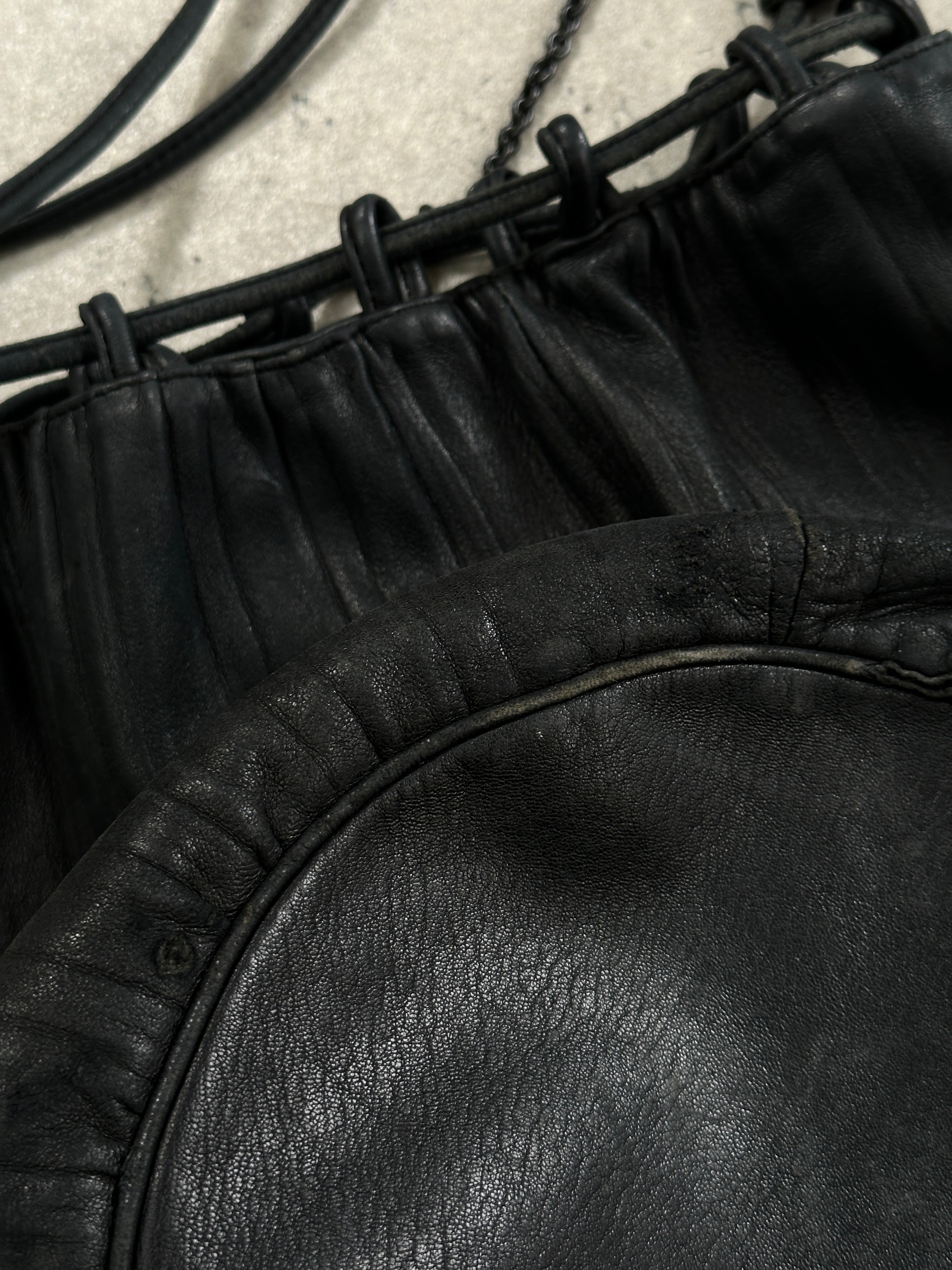 Giorgio Armani Le Collezioni leather rucksack bag with adjustable straps and sleek design, displayed on a plain background.